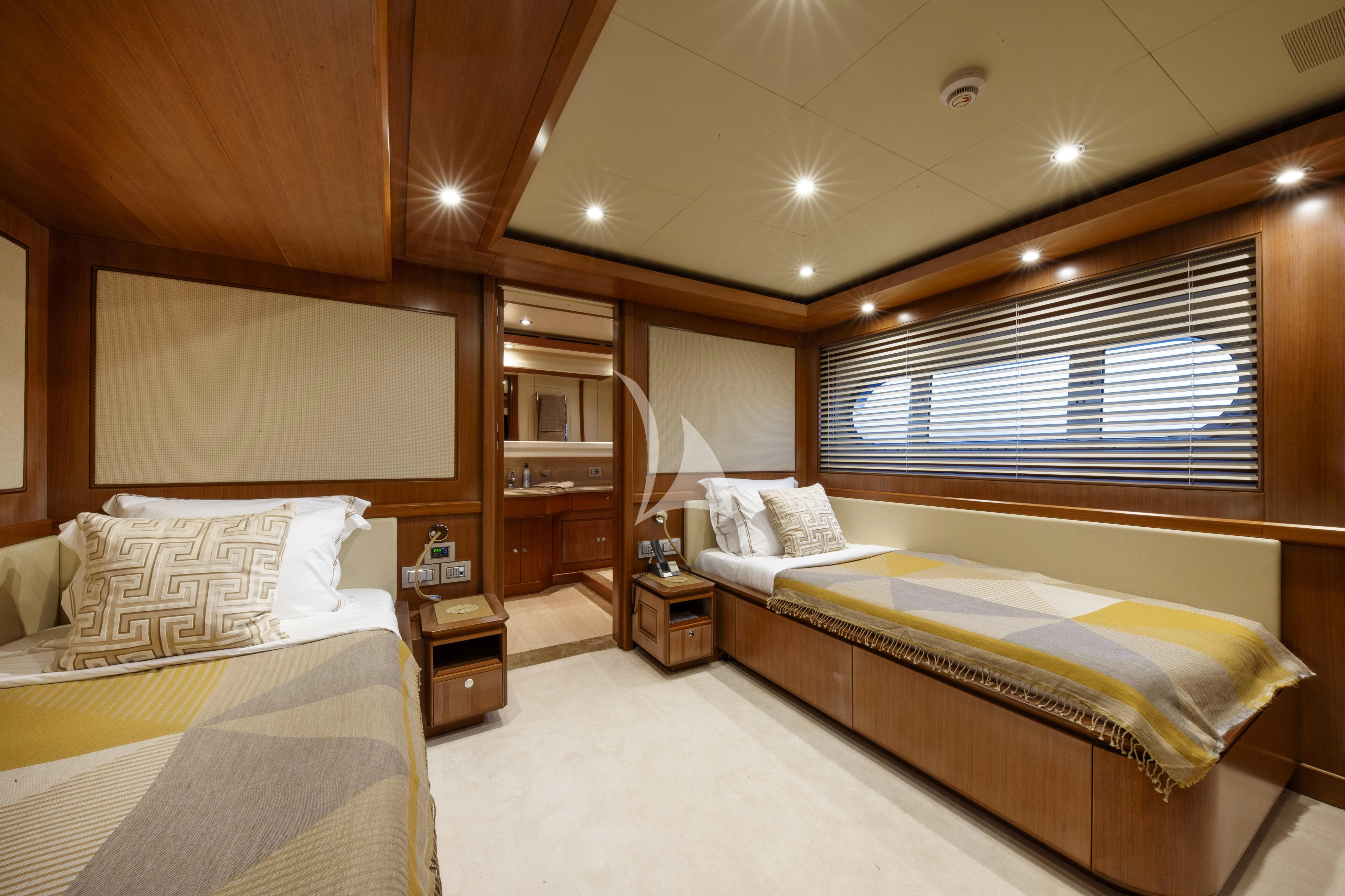 a room with two beds aboard O'LION Yacht for Sale
