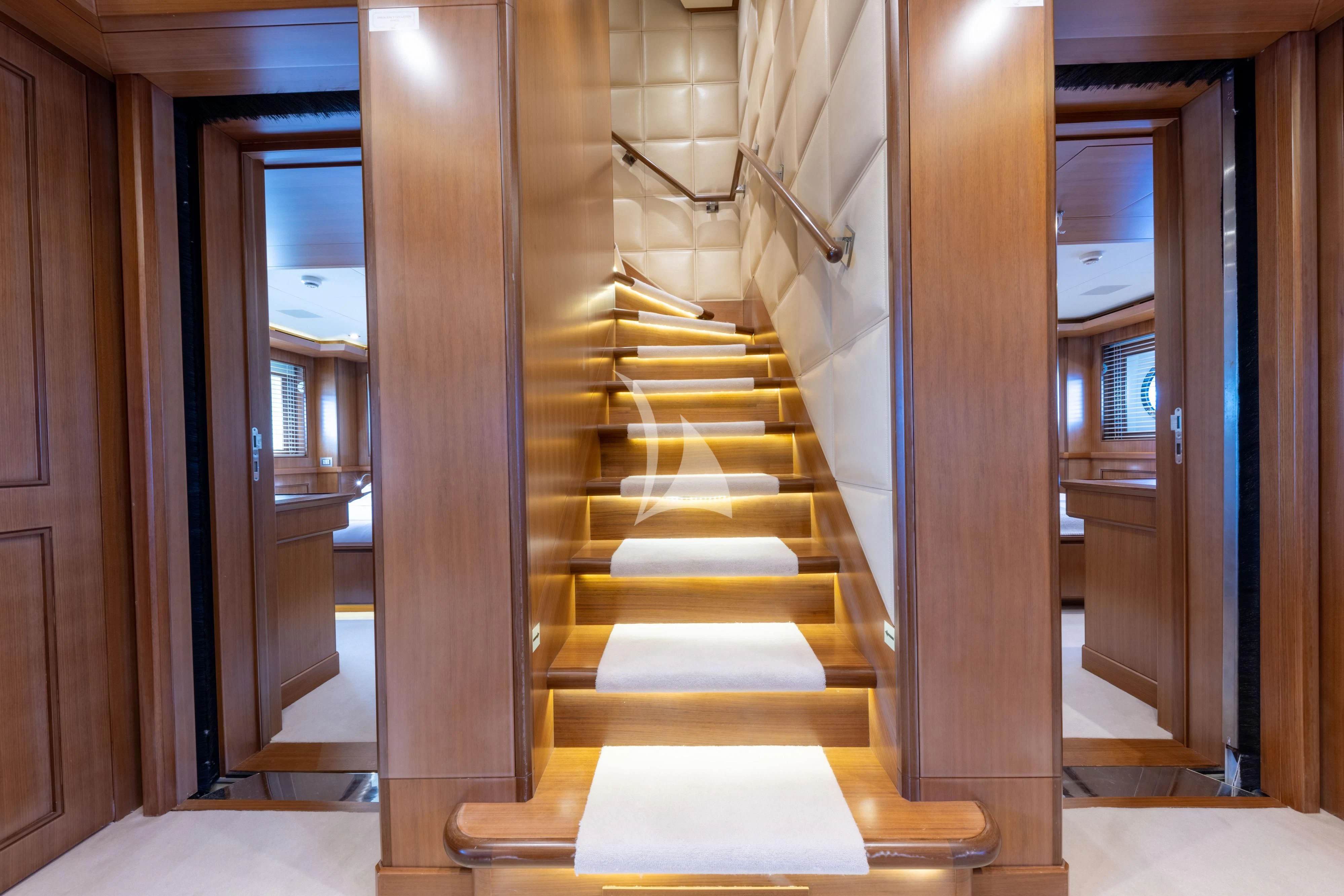 a wooden staircase in a house aboard O'LION Yacht for Sale