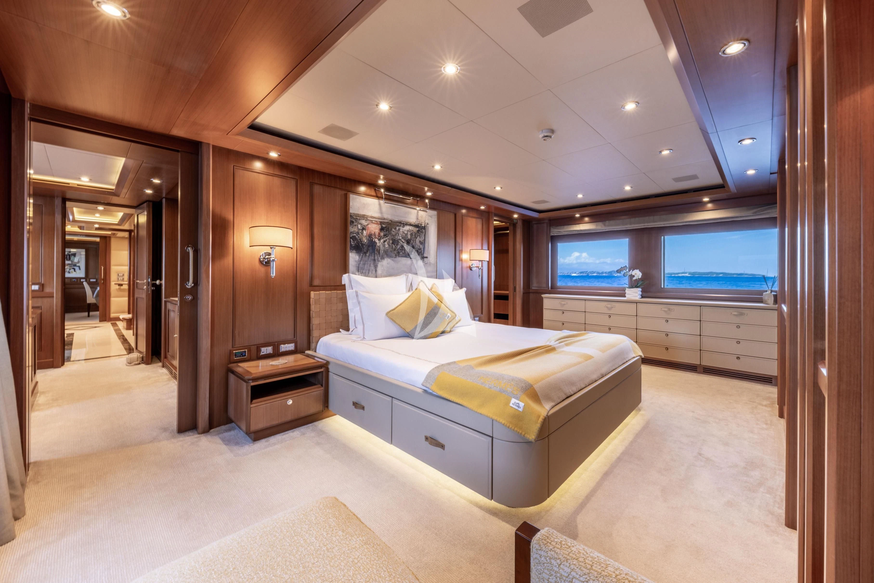 a bedroom with a bed and a tv aboard O'LION Yacht for Sale