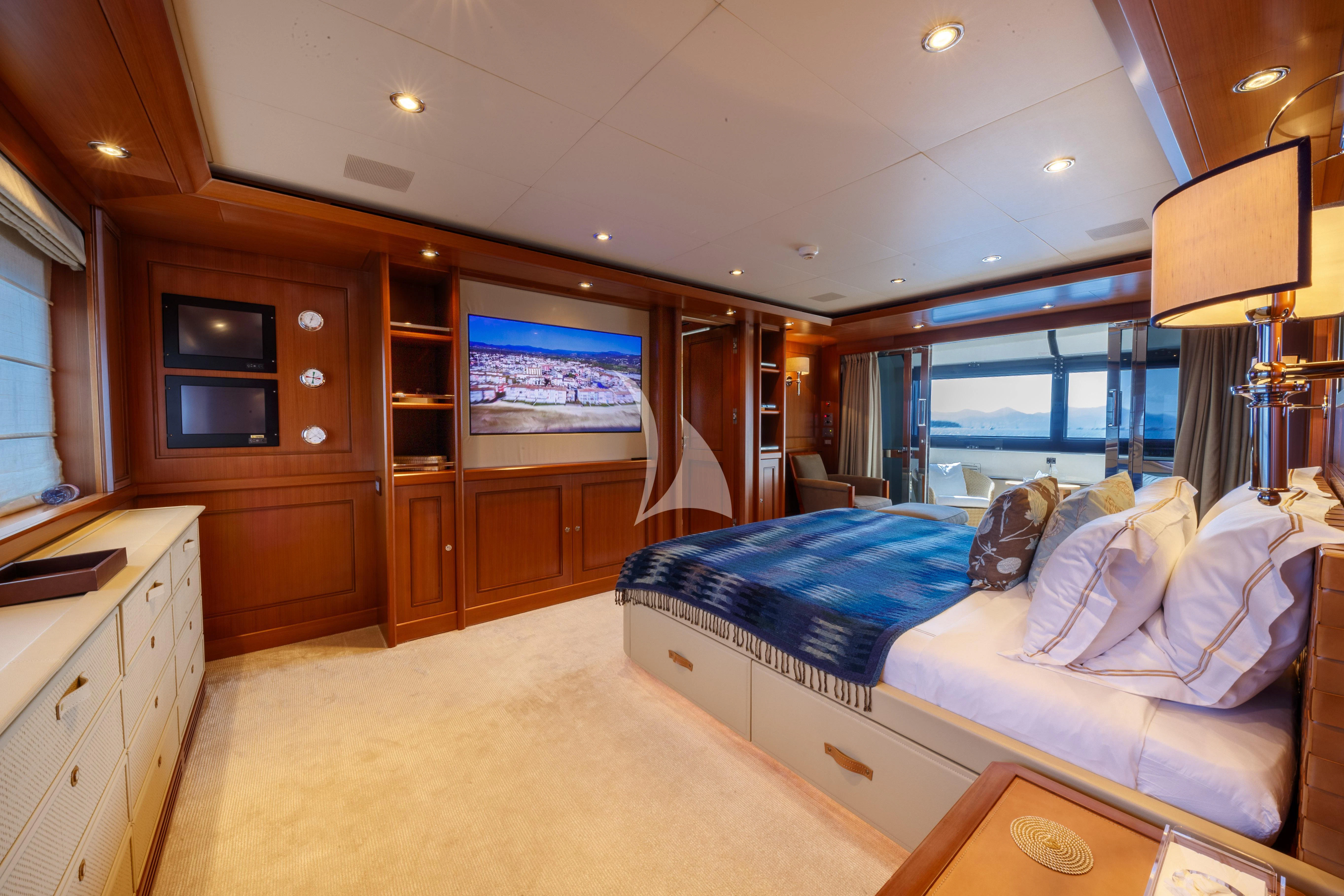 a bedroom with a bed and a tv aboard O'LION Yacht for Sale