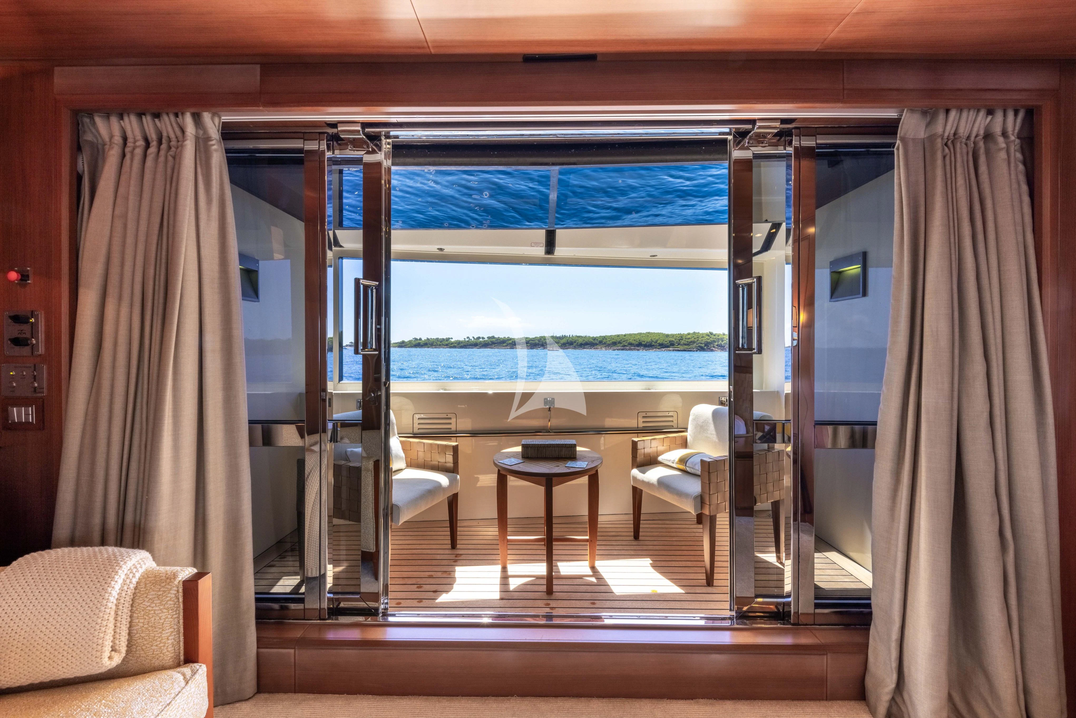 a room with a view of the water and the beach aboard O'LION Yacht for Sale