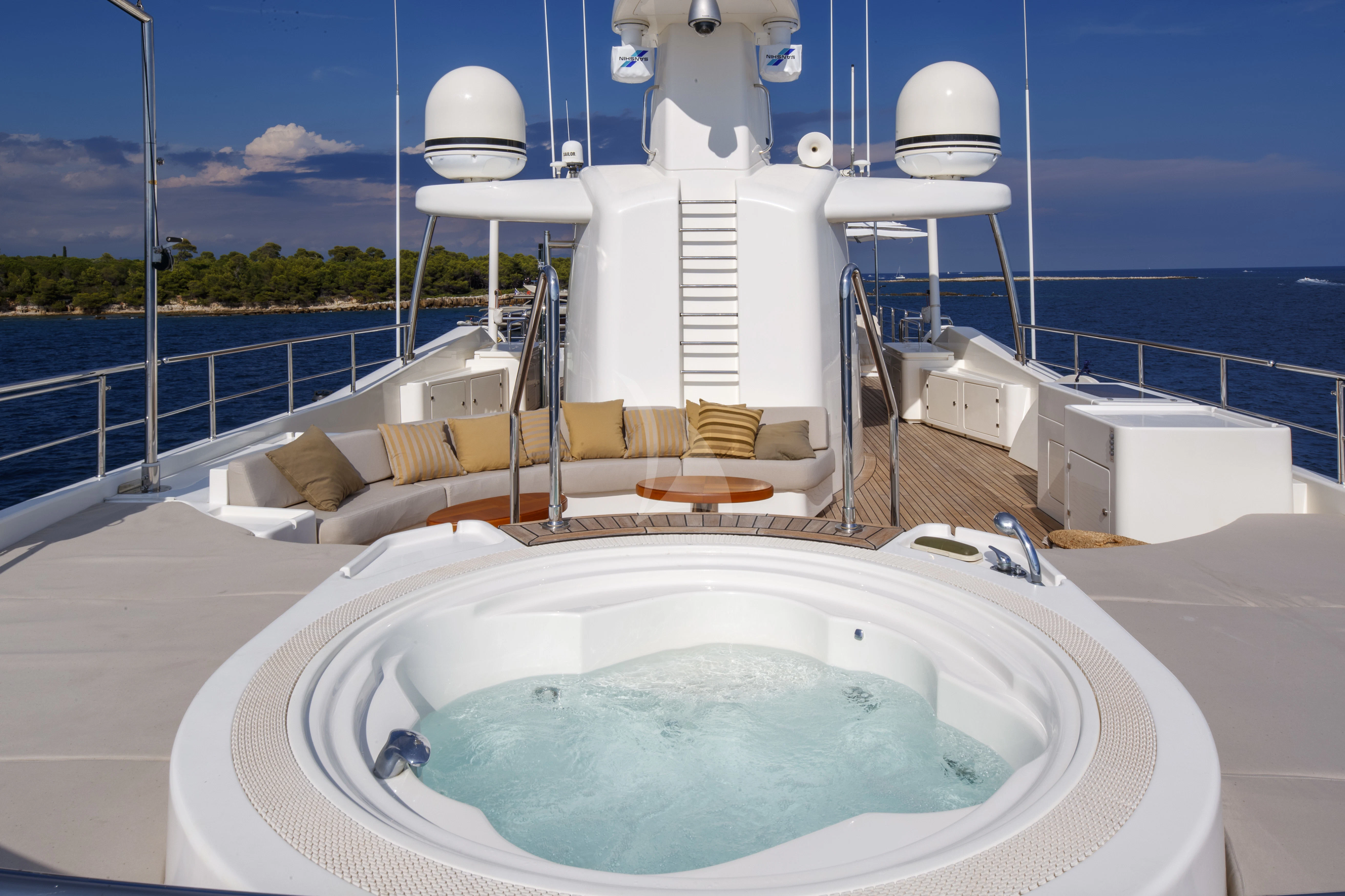 a white bathtub with a large white tub in a room with a large window and a view aboard O'LION Yacht for Sale
