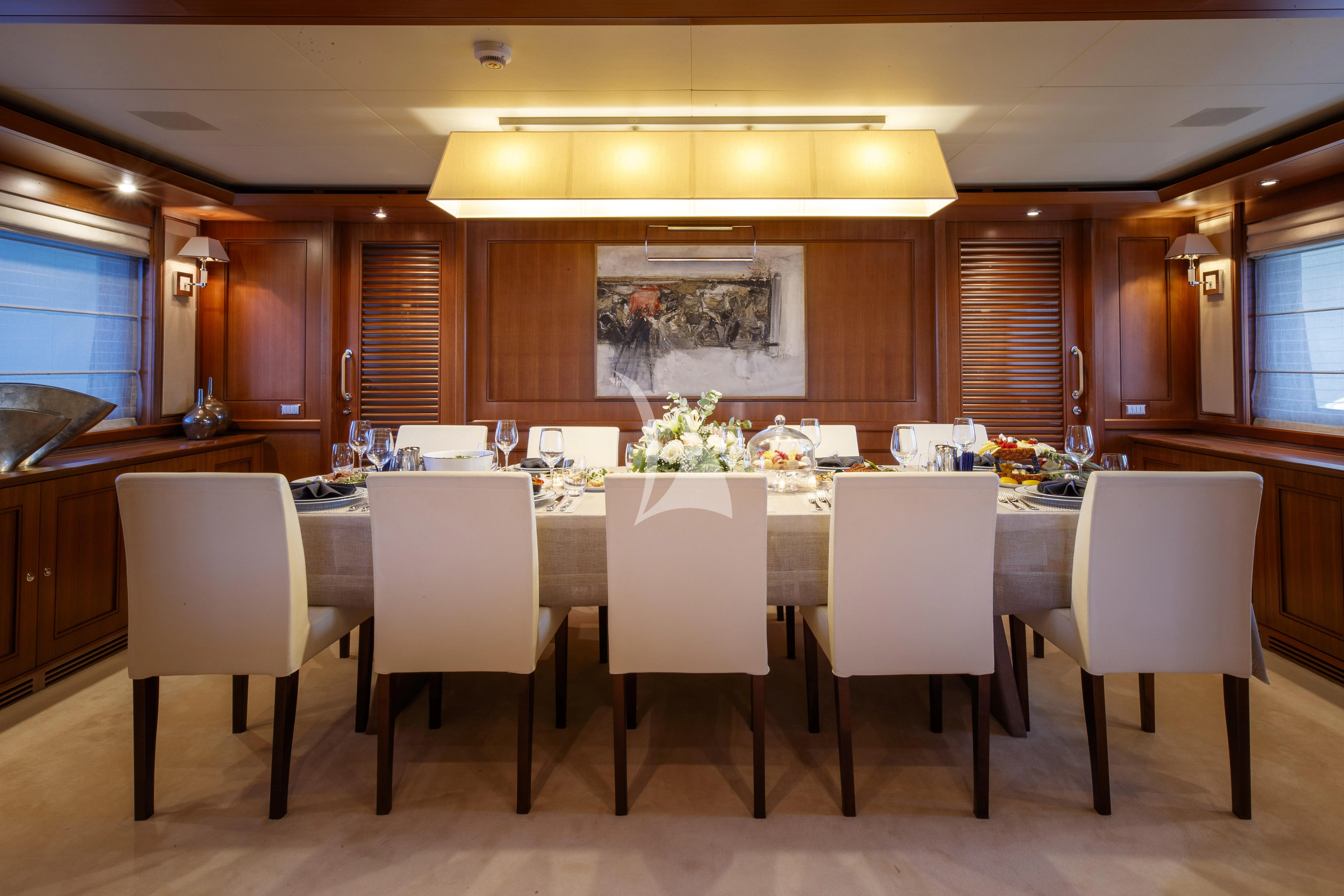 a large kitchen with a table and chairs aboard O'LION Yacht for Sale