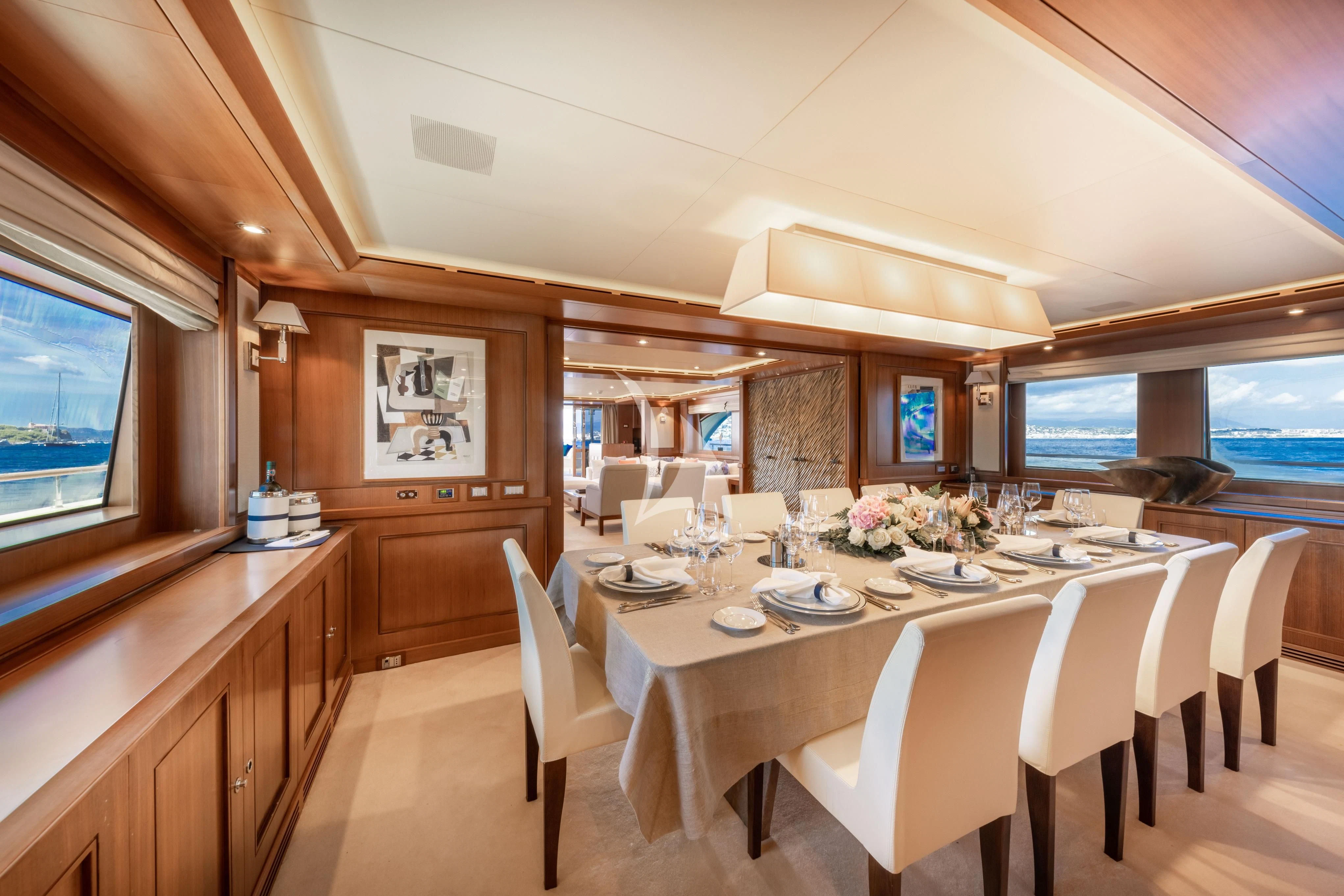 a large room with tables and chairs aboard O'LION Yacht for Sale