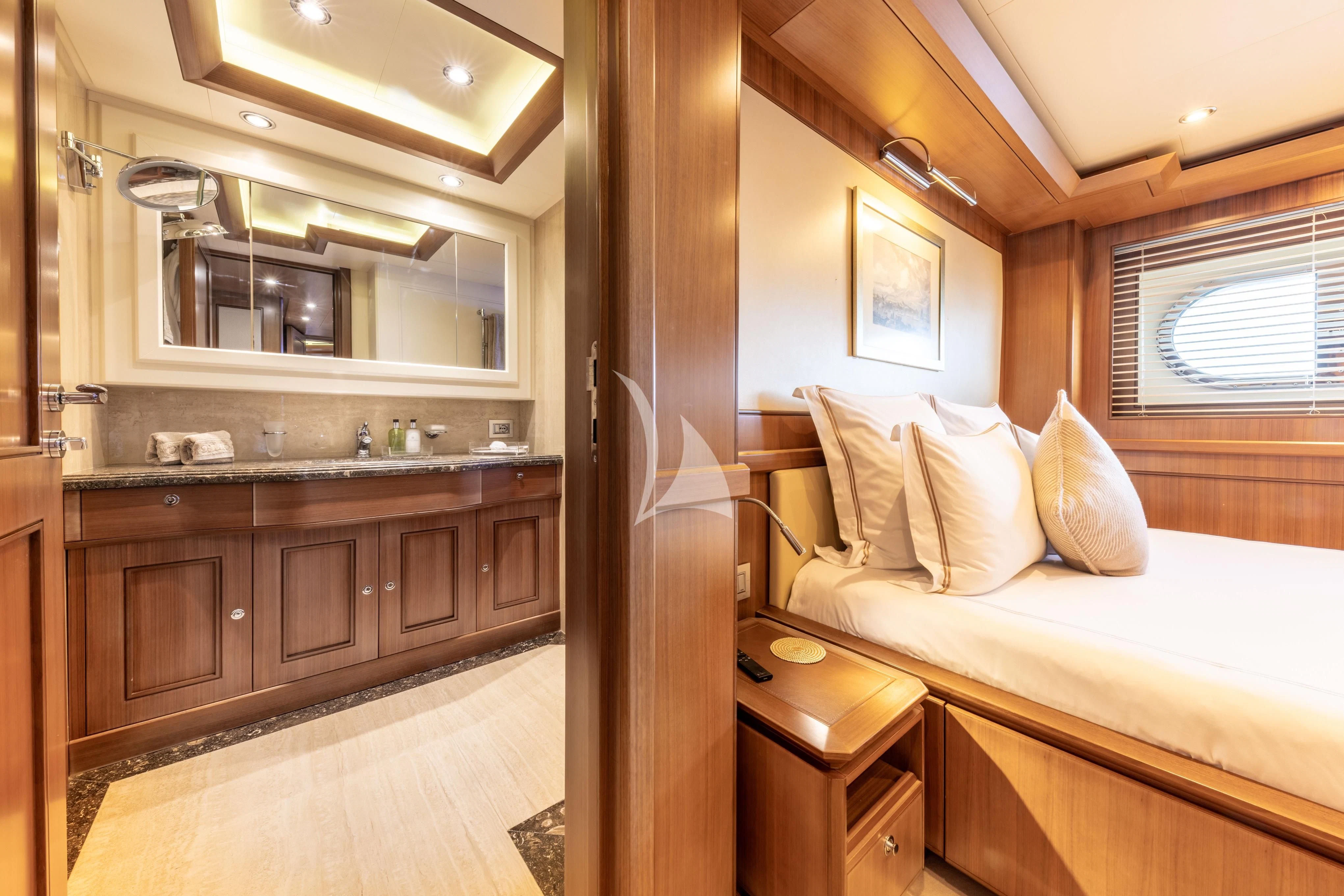 a bedroom with a bed and a mirror aboard O'LION Yacht for Sale