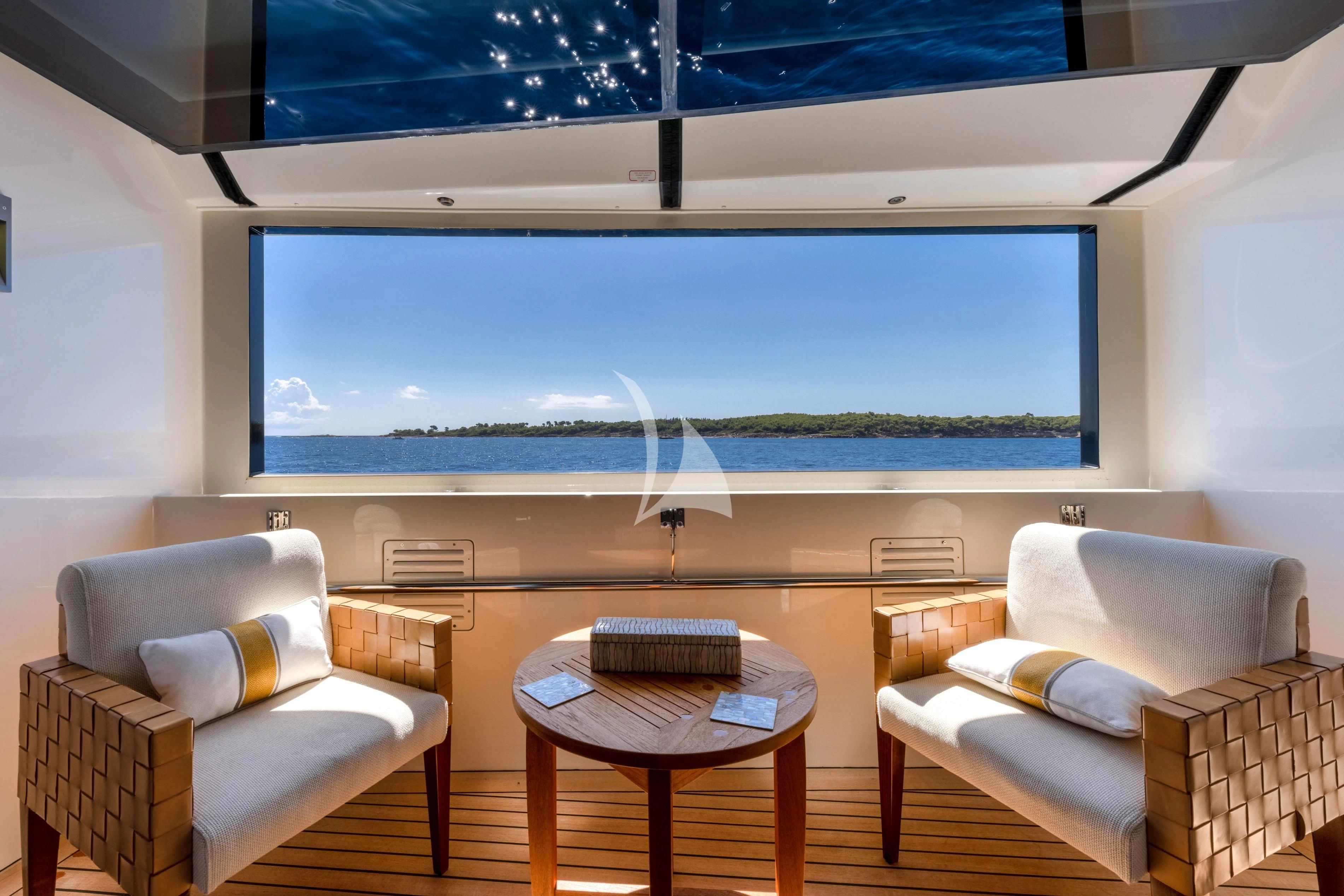 a room with a couch and a table and a large screen aboard O'LION Yacht for Sale