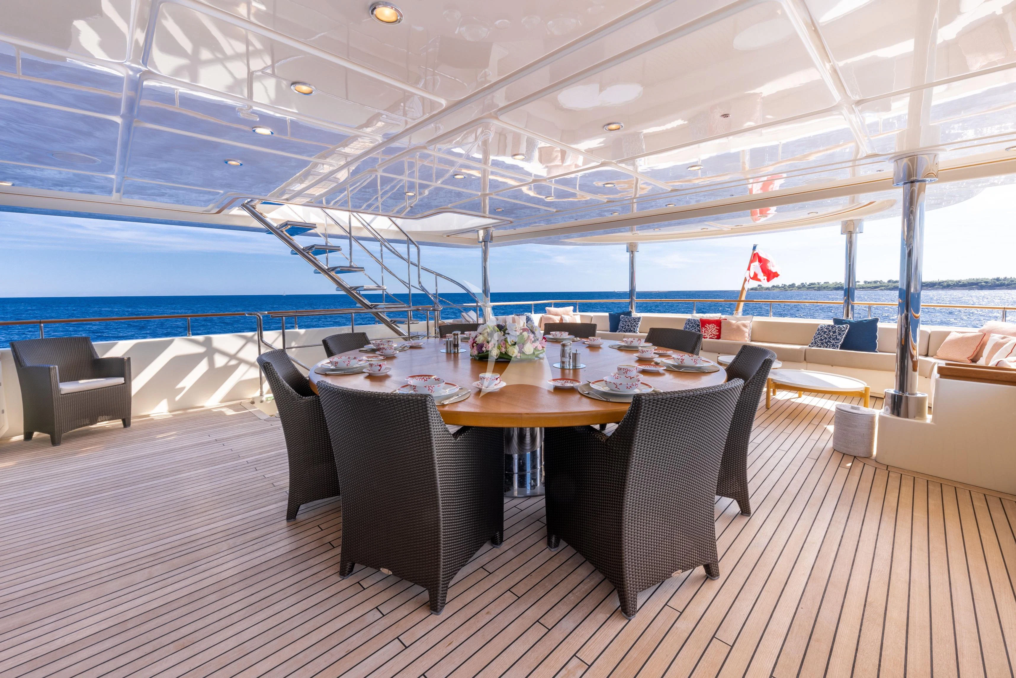 a room with a table and chairs aboard O'LION Yacht for Sale