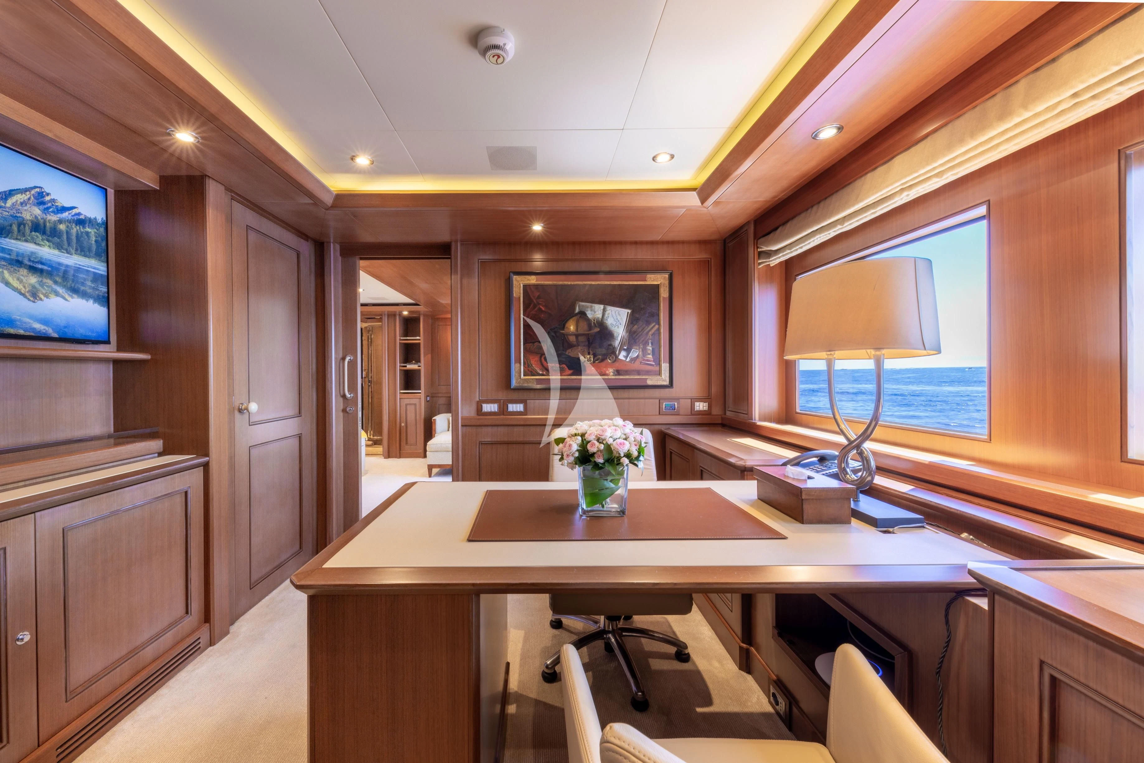 a room with a table and chairs aboard O'LION Yacht for Sale