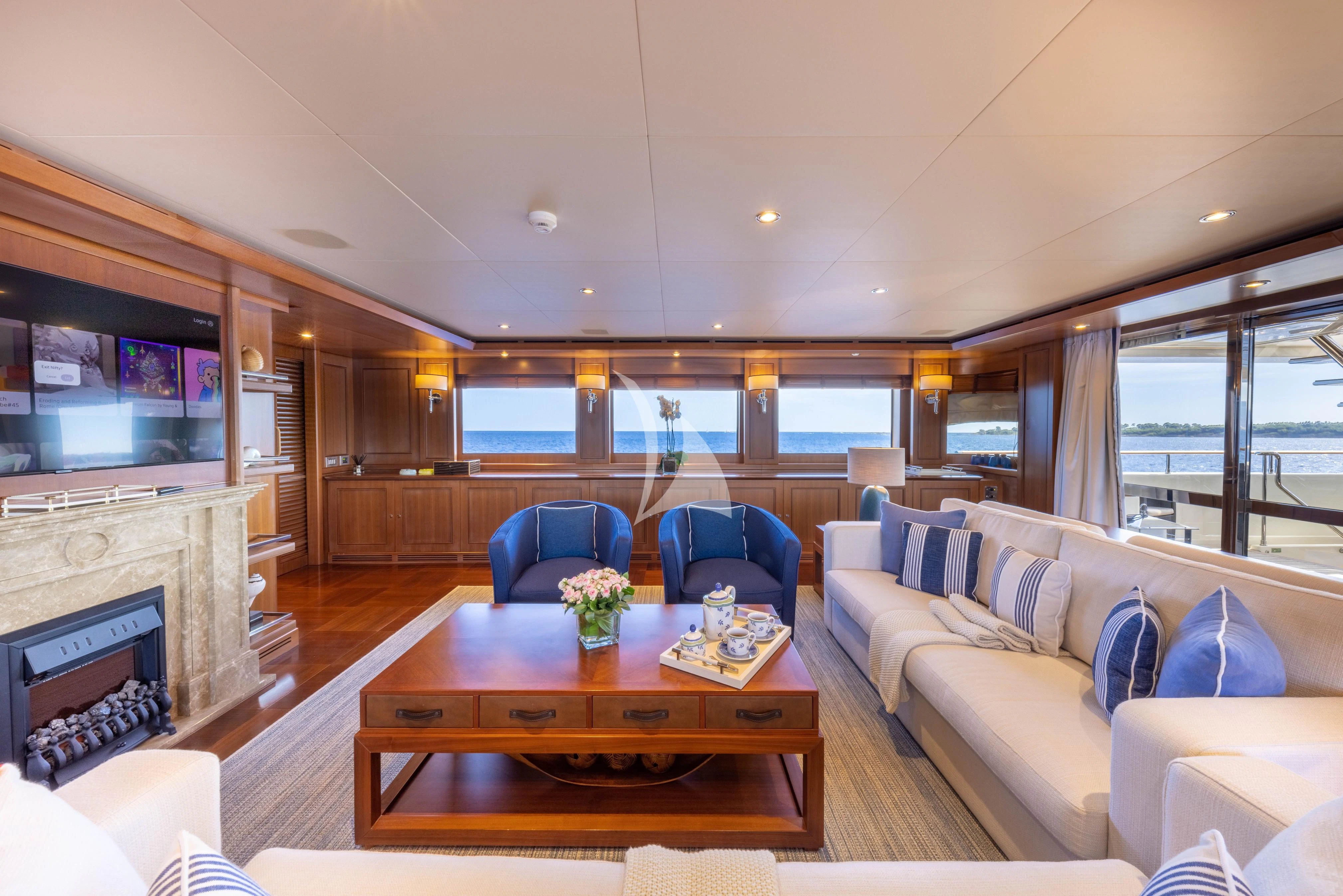 a living room with a fireplace aboard O'LION Yacht for Sale