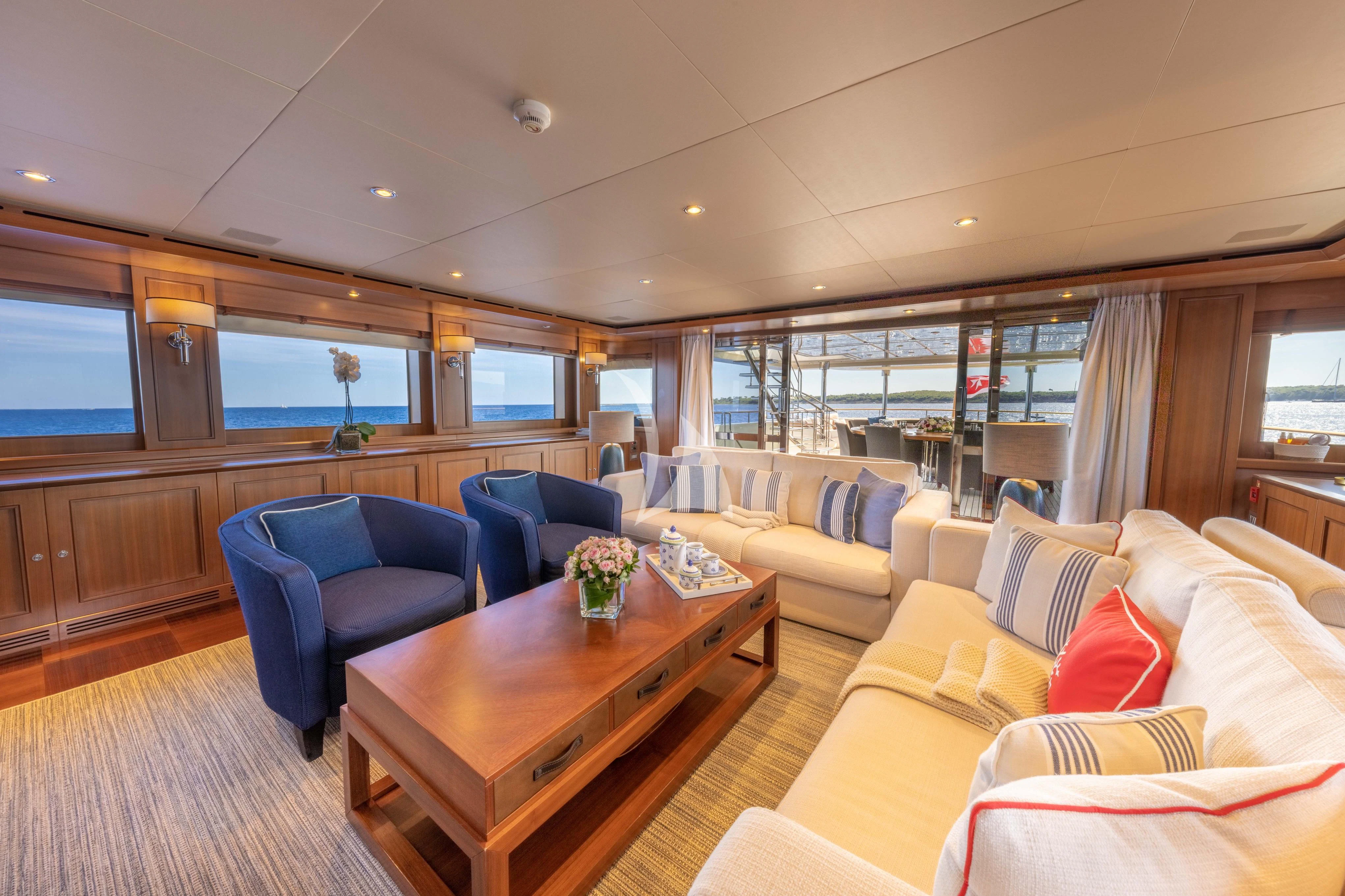 a living room with a table and chairs aboard O'LION Yacht for Sale