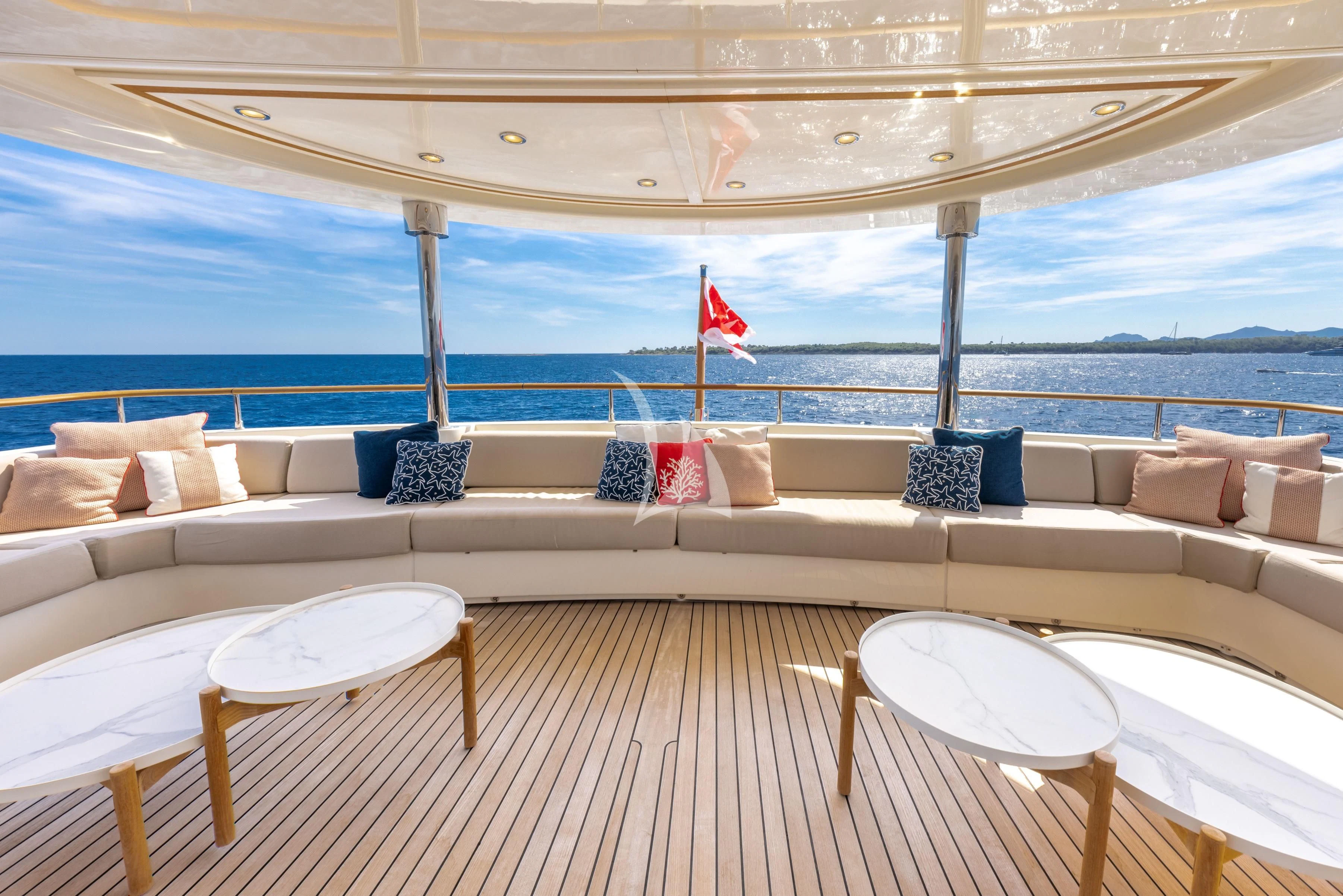 a couch and table on a deck aboard O'LION Yacht for Sale