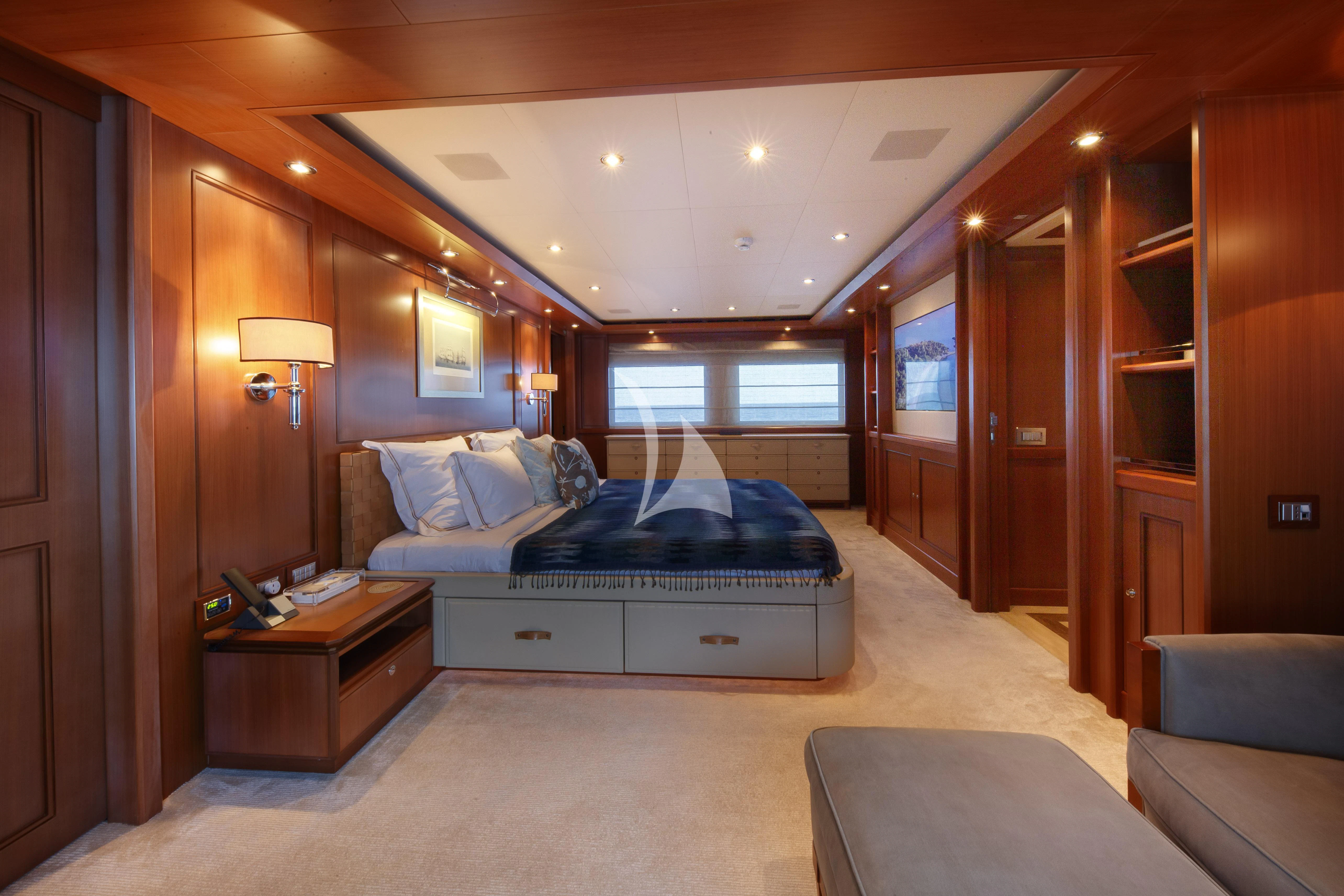 a bedroom with a bed and a desk aboard O'LION Yacht for Sale