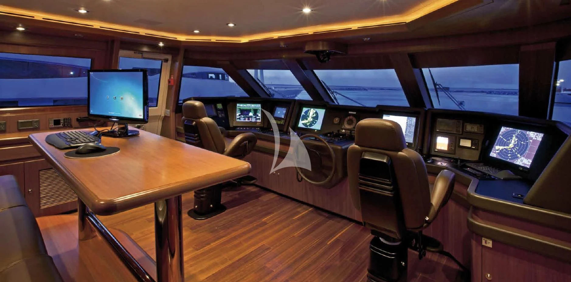 a room with a desk and computer screens aboard O'LION Yacht for Sale