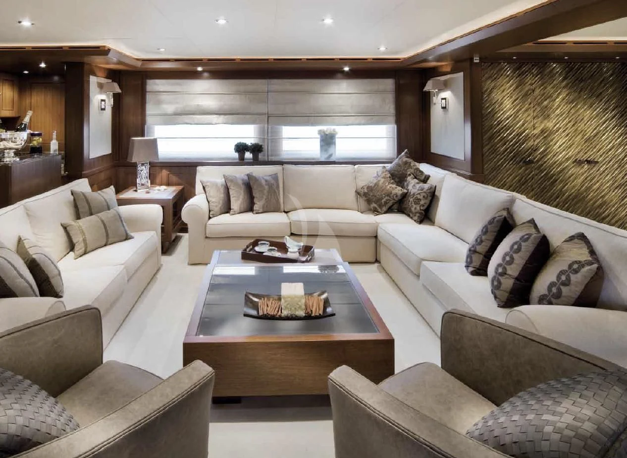a living room with a couch and a coffee table aboard O'LION Yacht for Sale