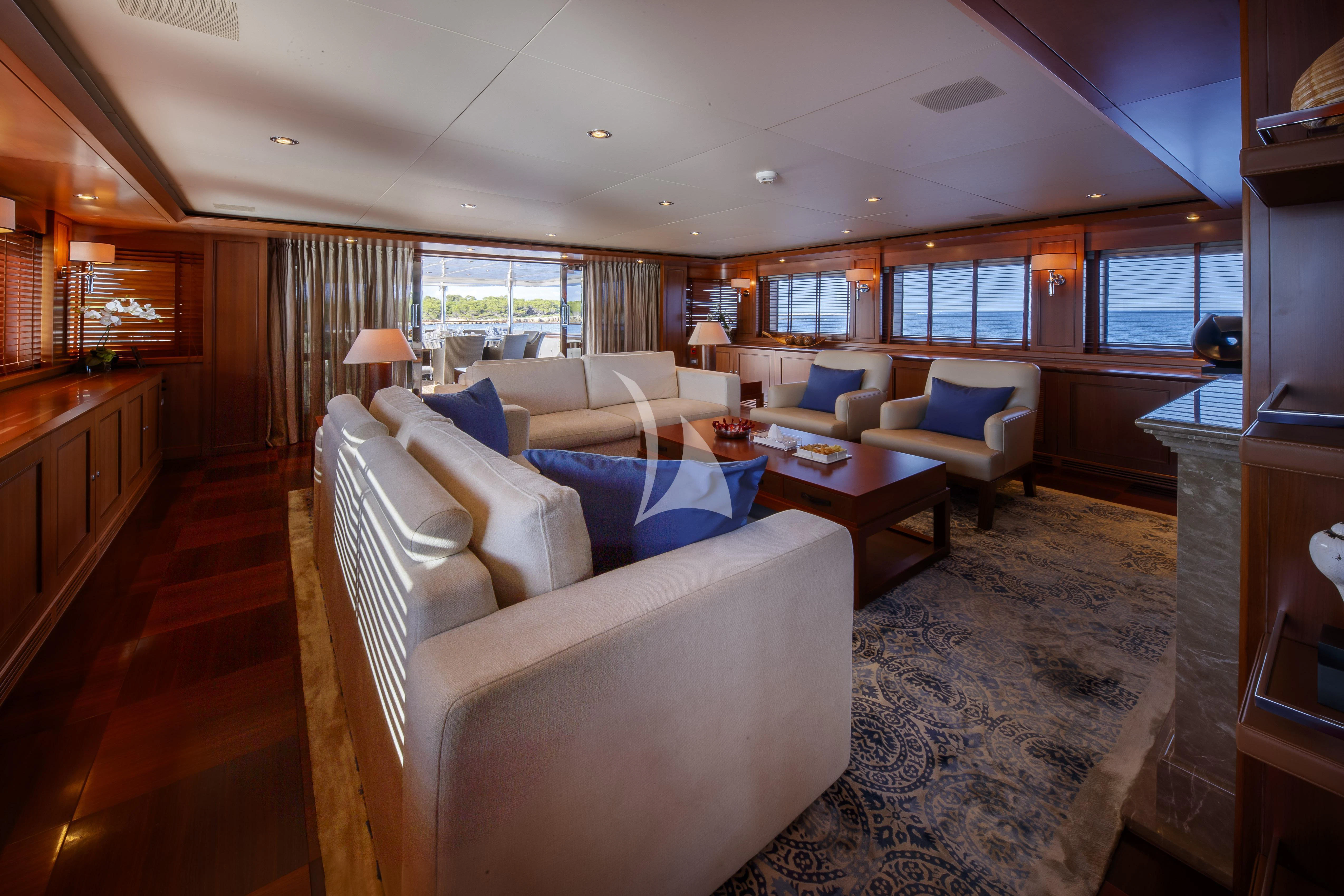 a living room with a couch and a table aboard O'LION Yacht for Sale