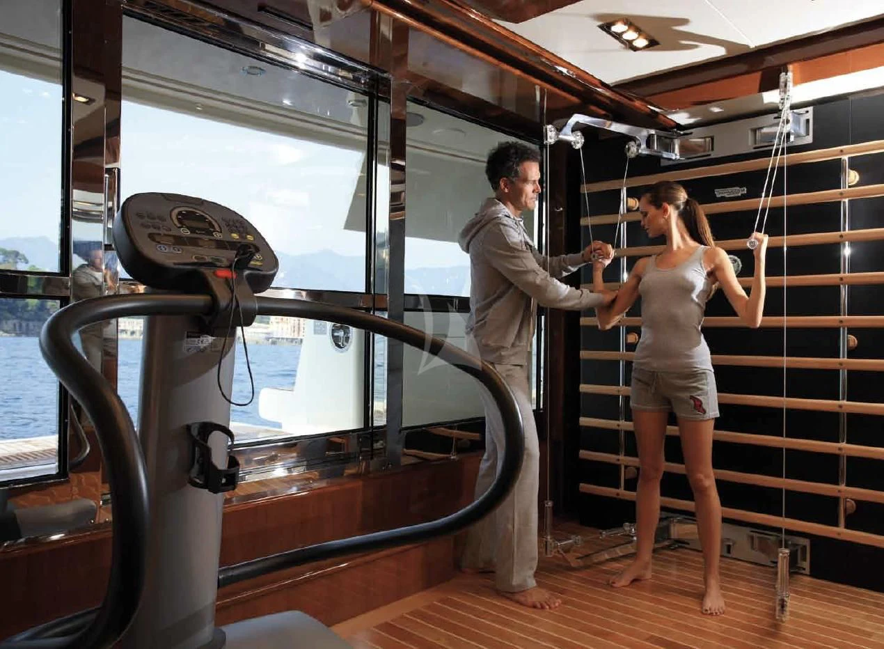 a man and a woman in a room with a mirror aboard O'LION Yacht for Sale