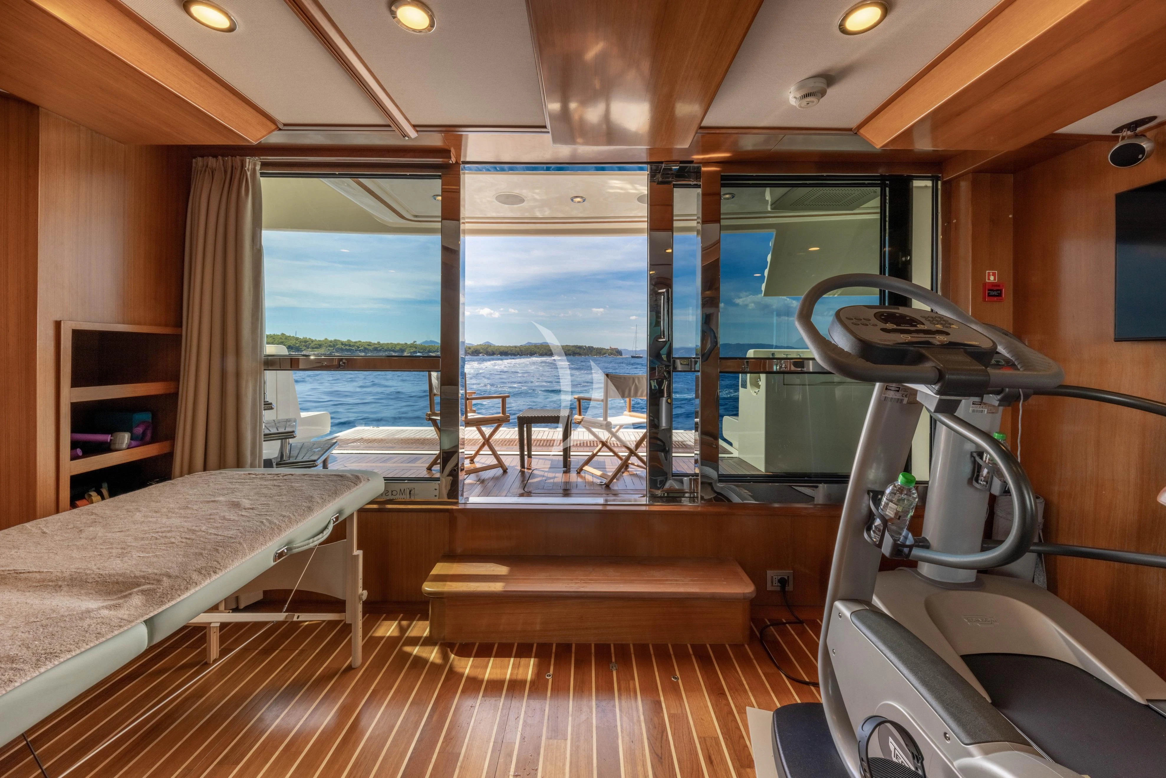 a room with a bed and a large window aboard O'LION Yacht for Sale