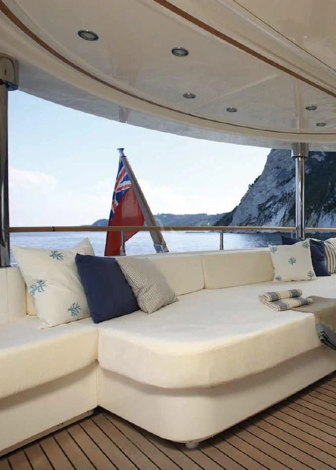 a bed with a flag on the side aboard O'LION Yacht for Sale