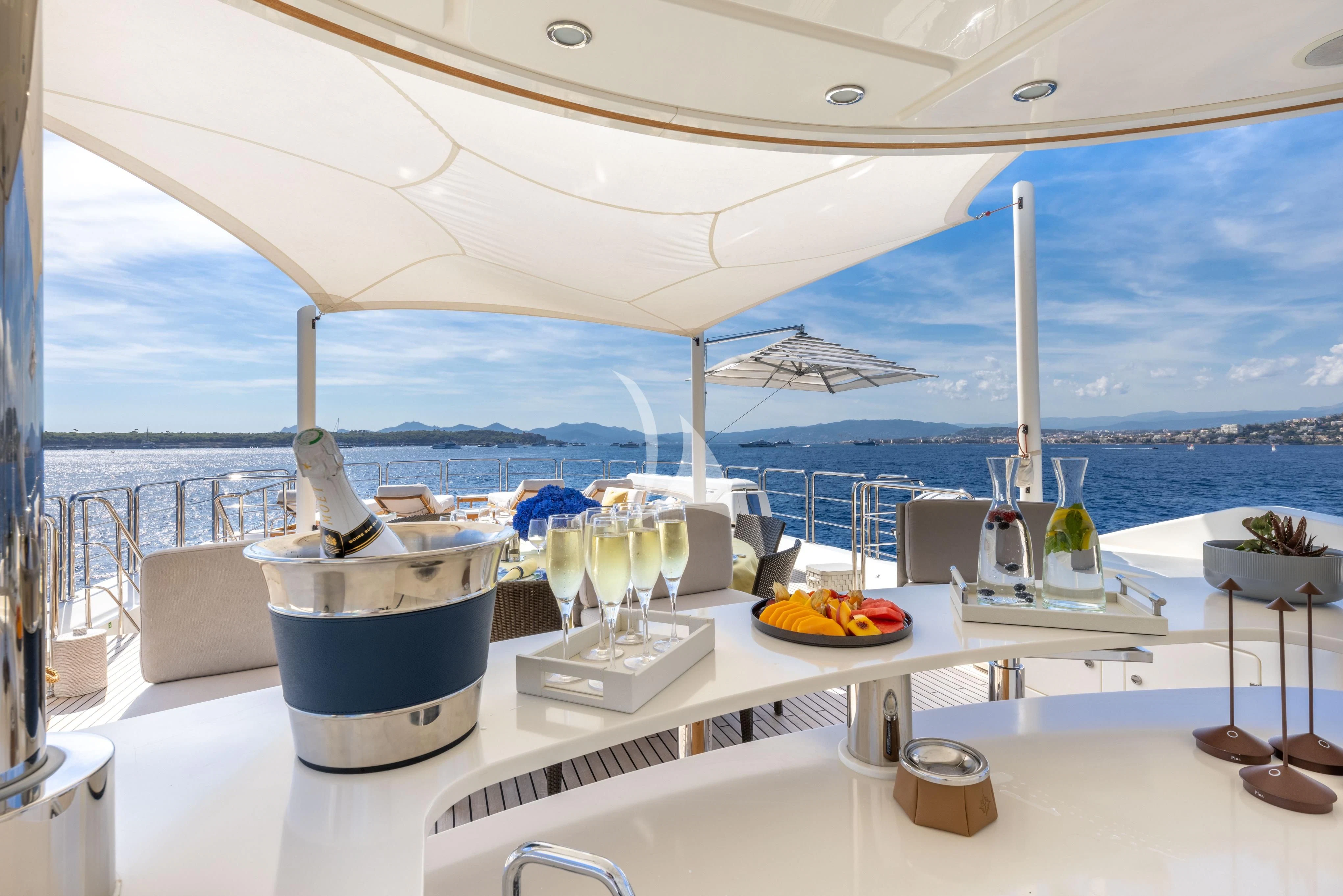 a table with food and drinks on it aboard O'LION Yacht for Sale