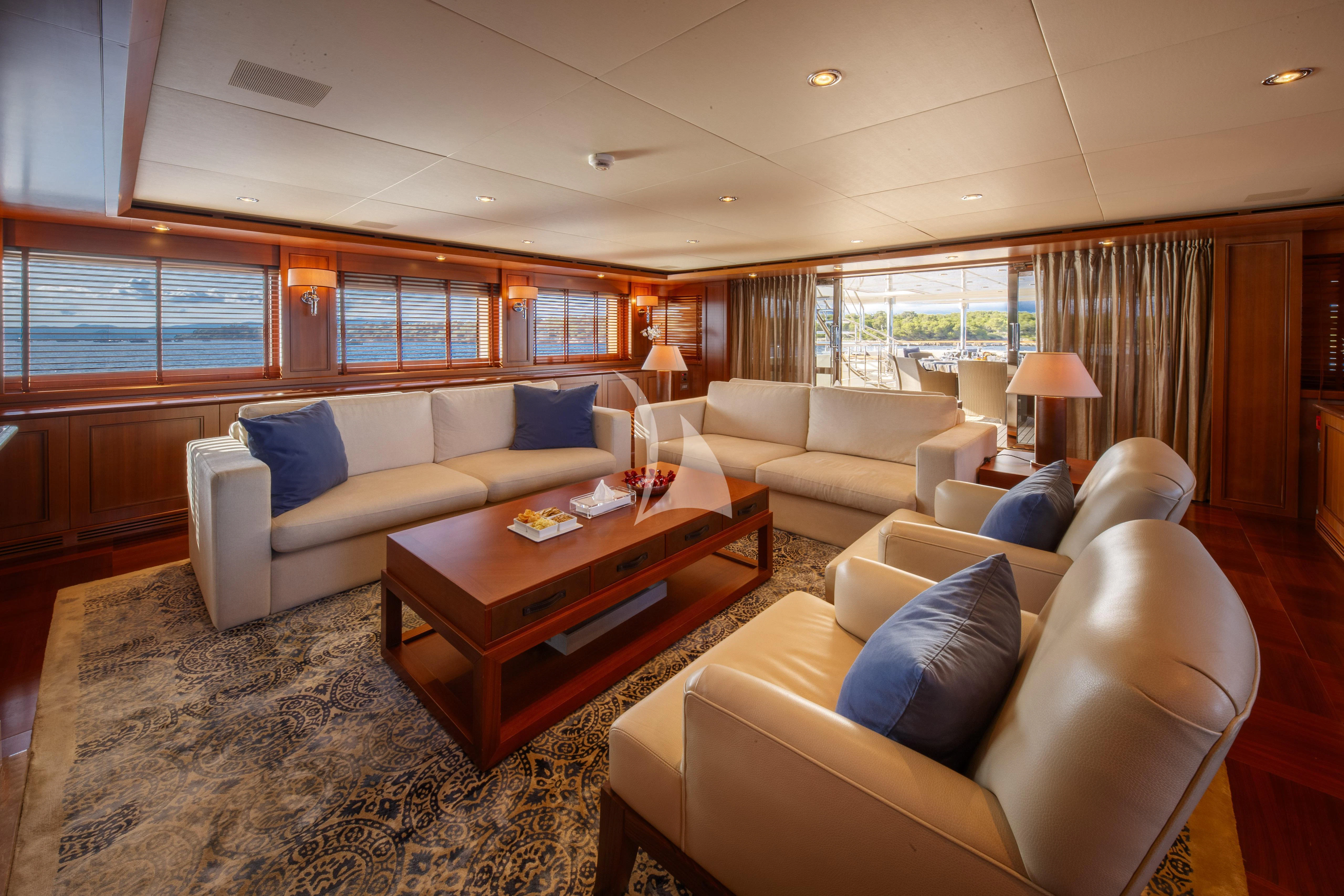 a living room with a couch and a coffee table aboard O'LION Yacht for Sale