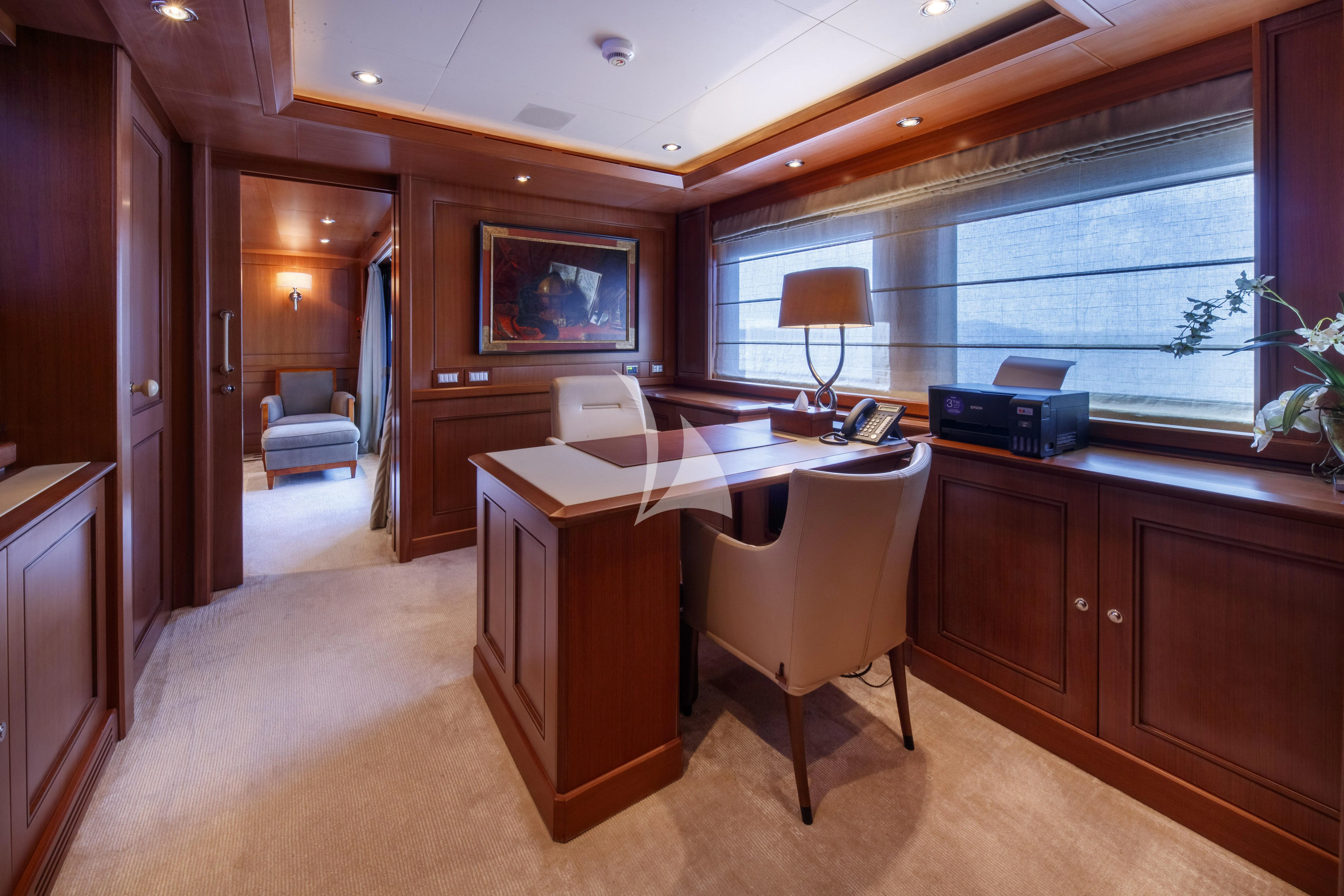 a room with a desk and a chair aboard O'LION Yacht for Sale