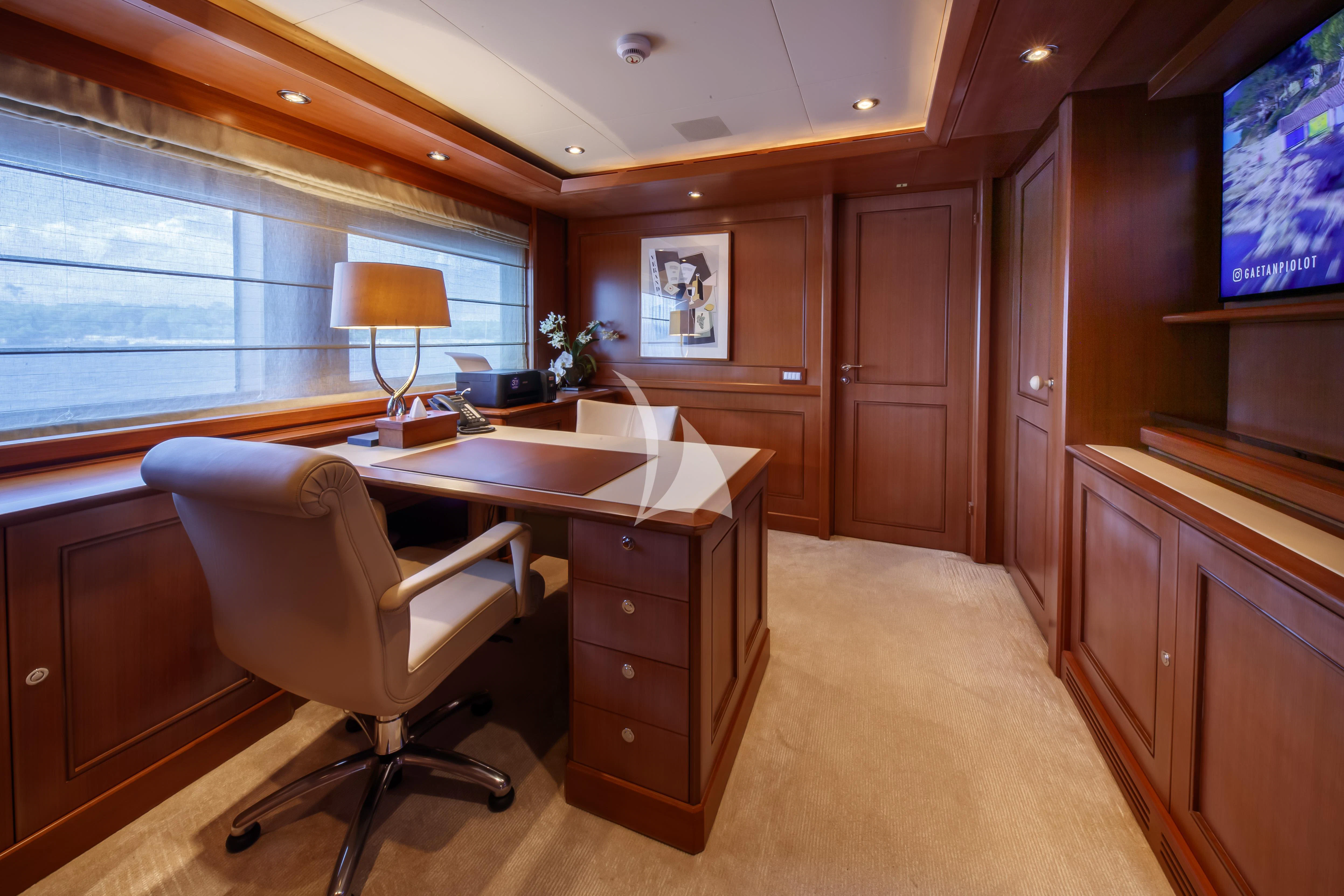 a room with a desk and a chair aboard O'LION Yacht for Sale