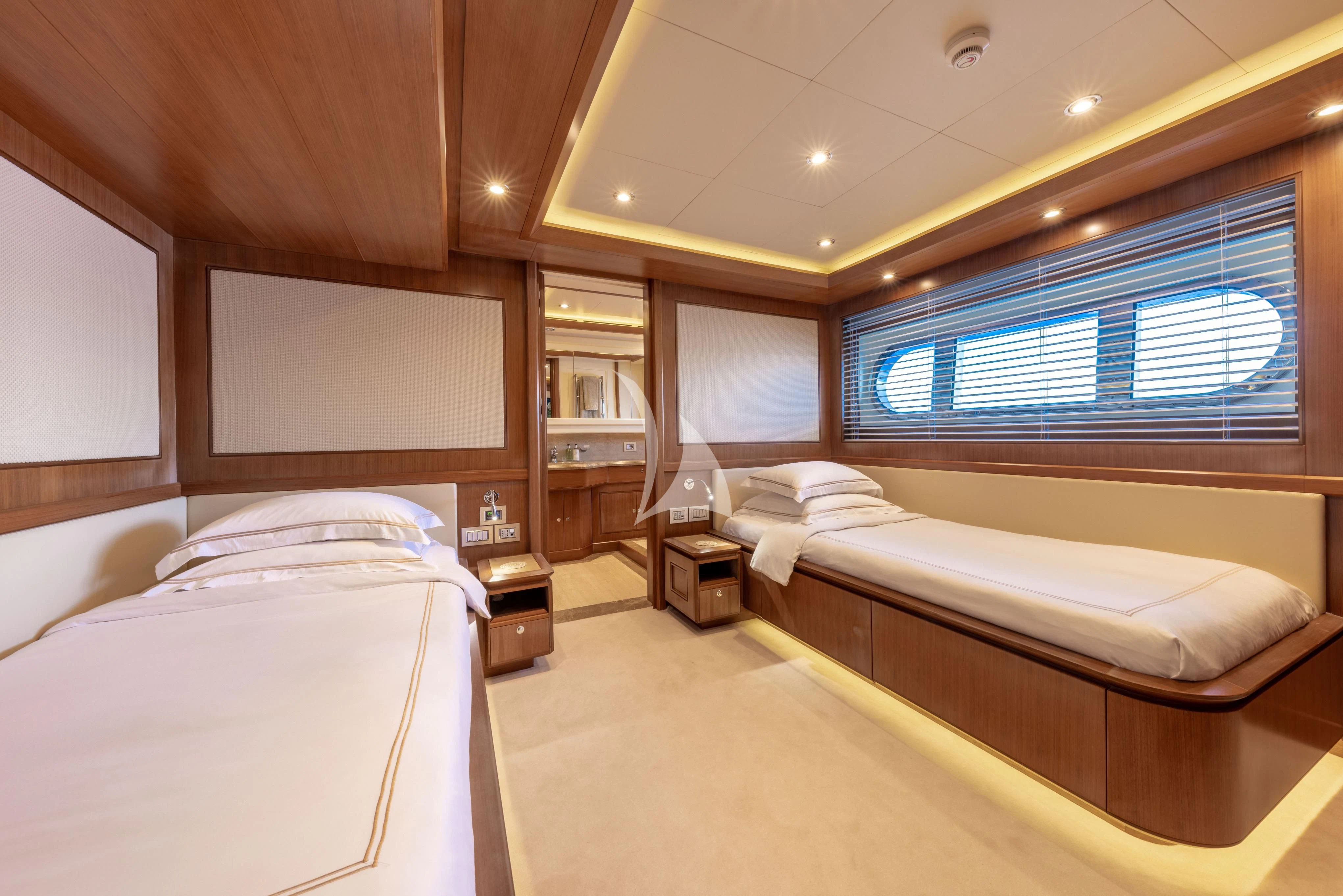 a room with two beds aboard O'LION Yacht for Sale