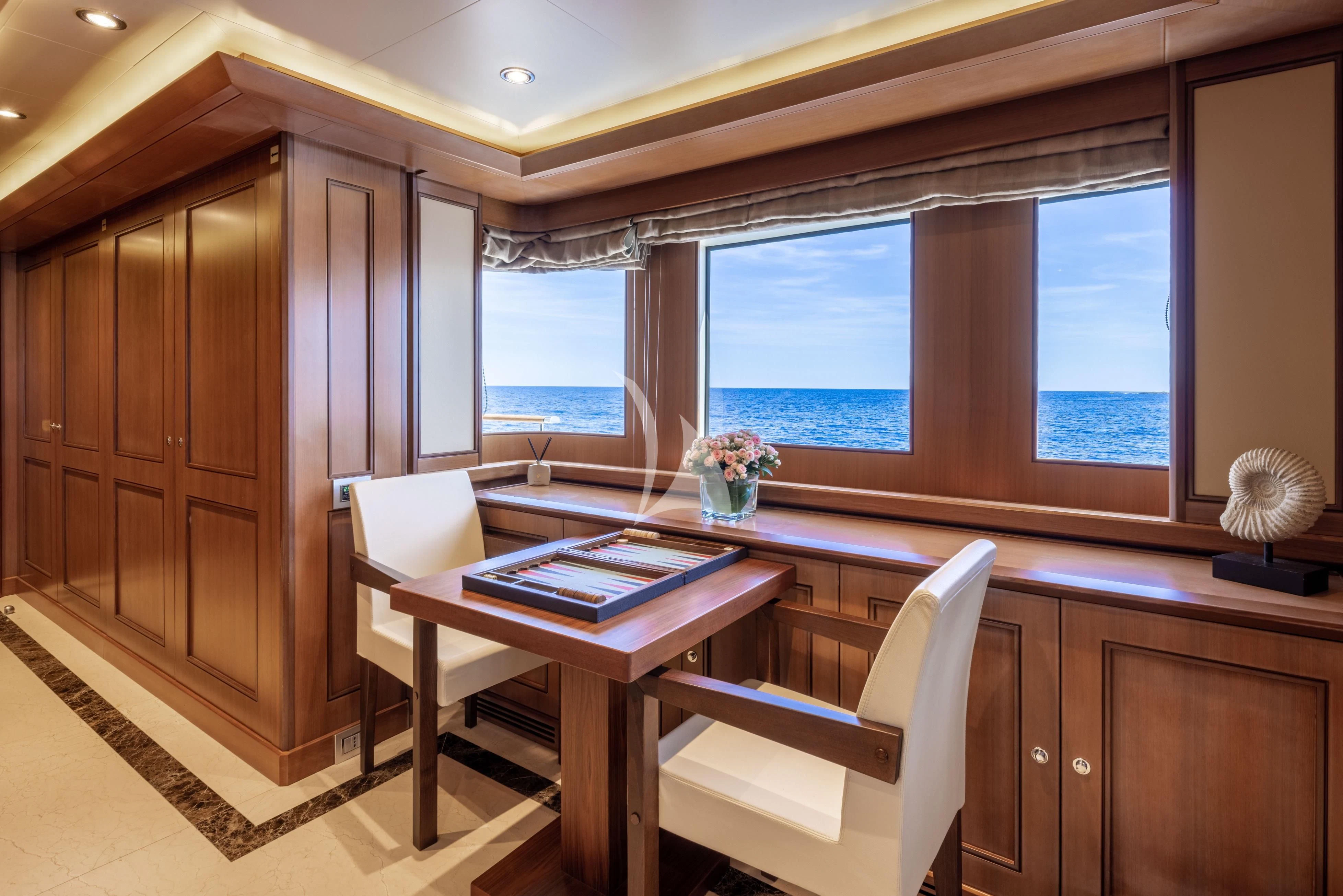 a room with a desk and a chair aboard O'LION Yacht for Sale