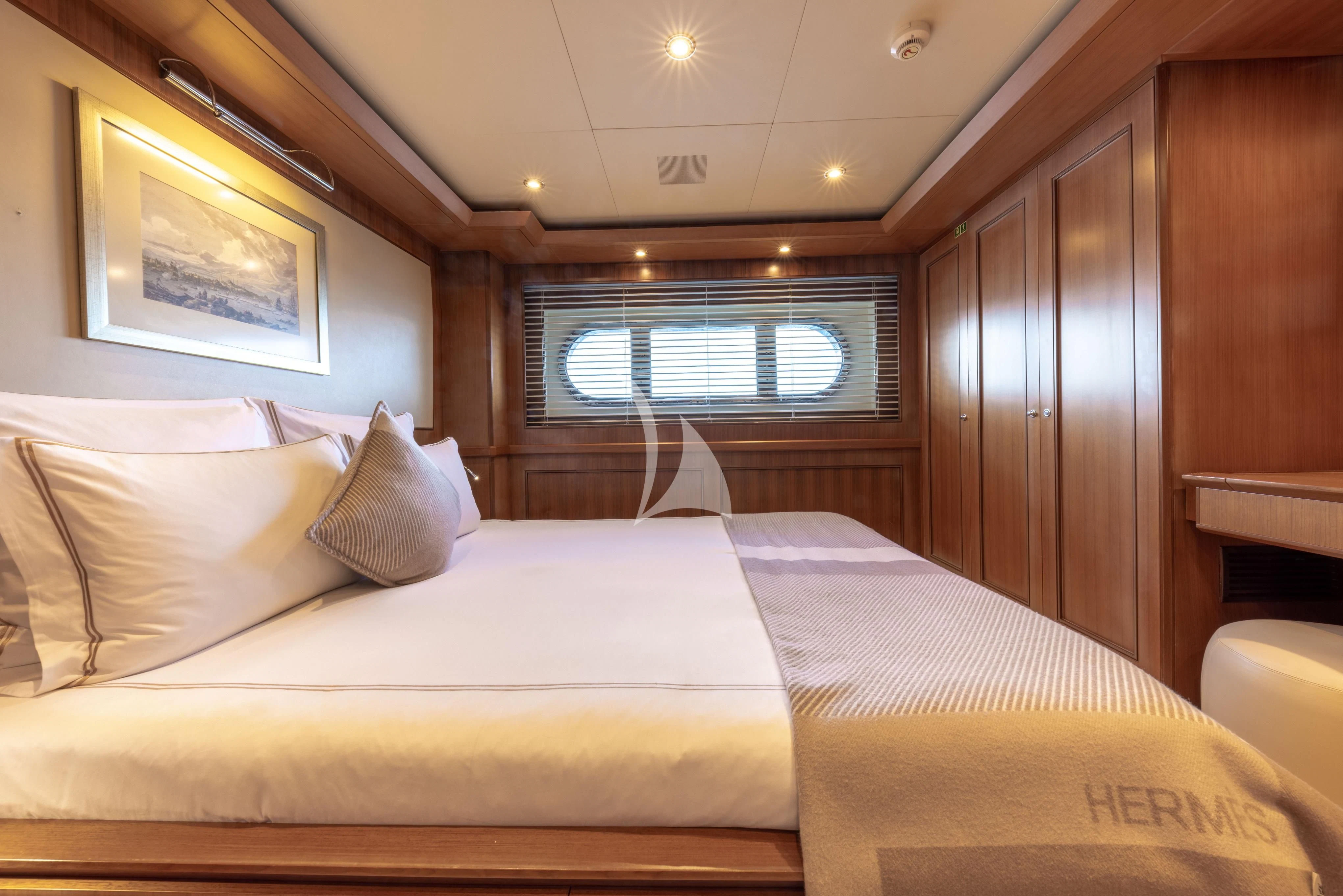 a bed with white sheets aboard O'LION Yacht for Sale
