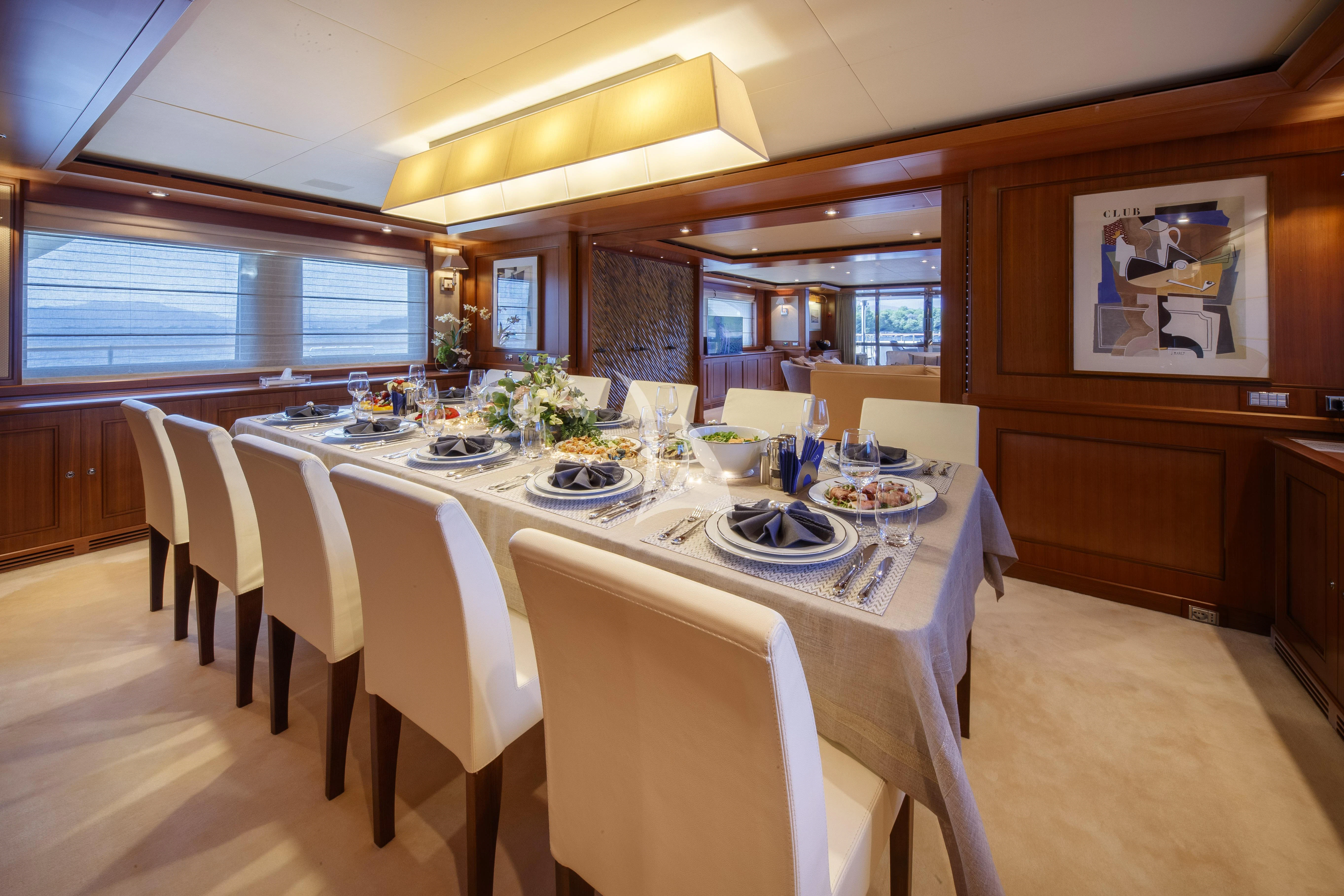 a large dining room with a table set for a meal aboard O'LION Yacht for Sale