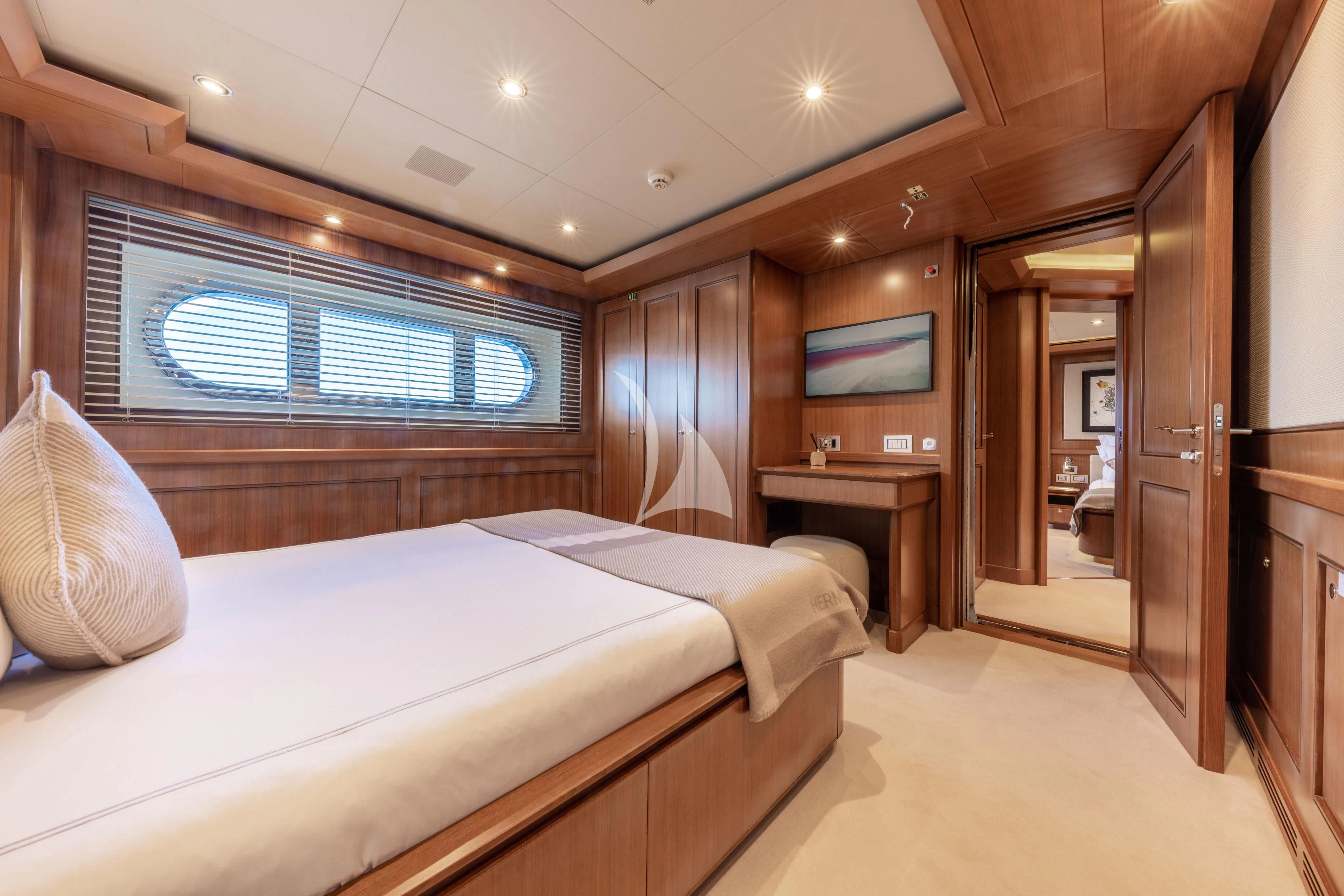 a room with a bed and a desk aboard O'LION Yacht for Sale
