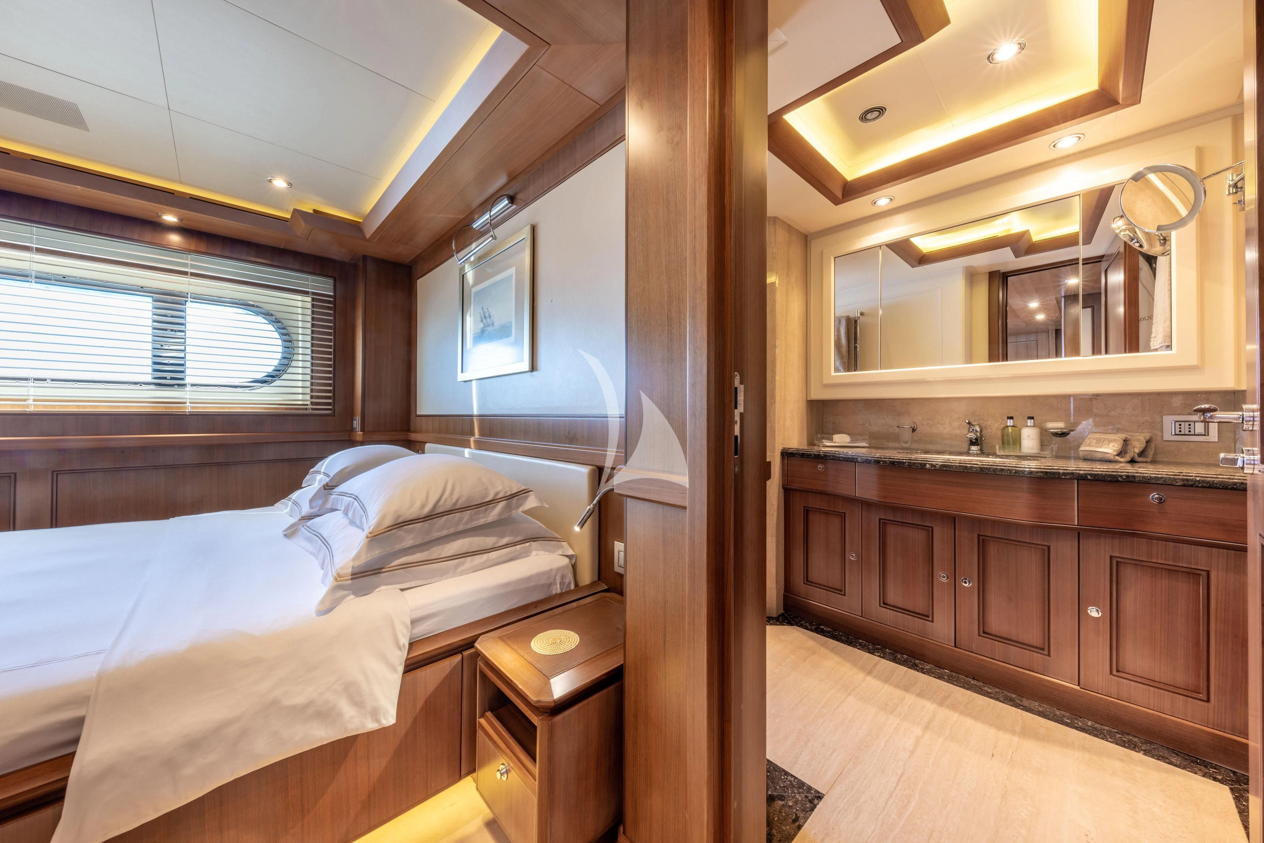 a bedroom with a bed and a sink aboard O'LION Yacht for Sale