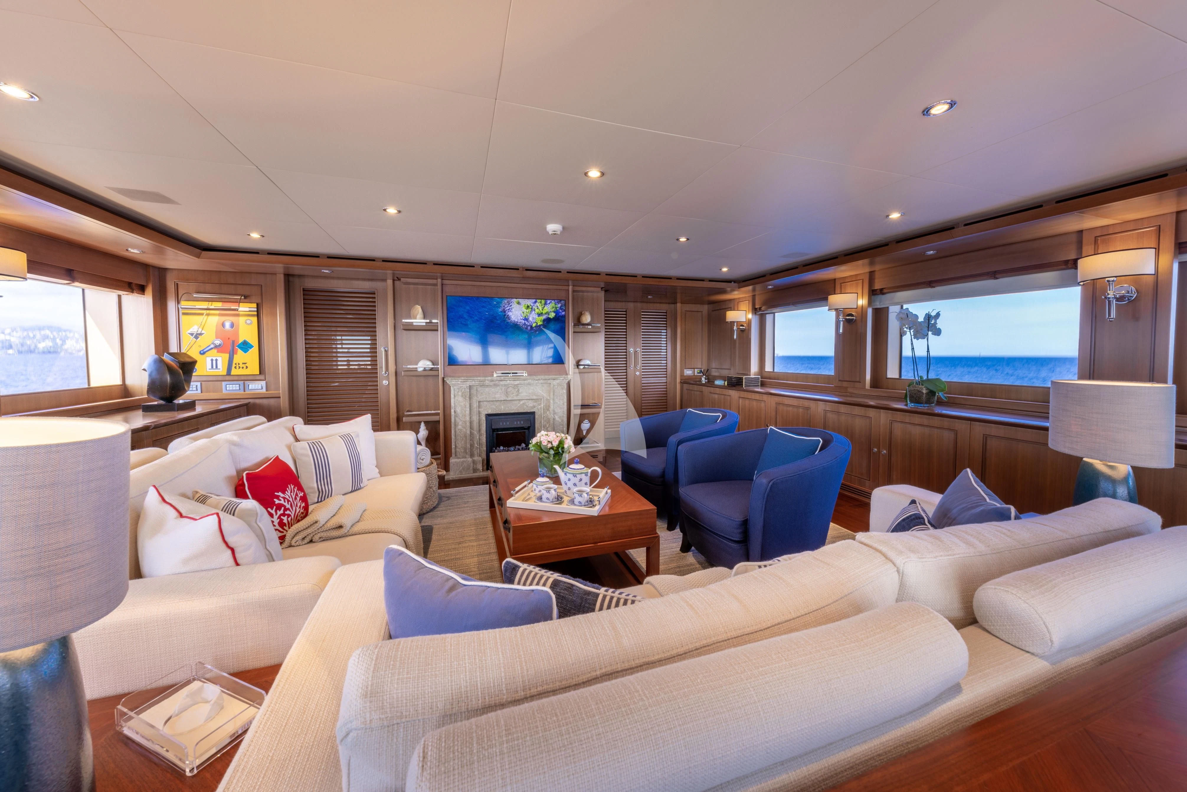 a living room with a fireplace aboard O'LION Yacht for Sale