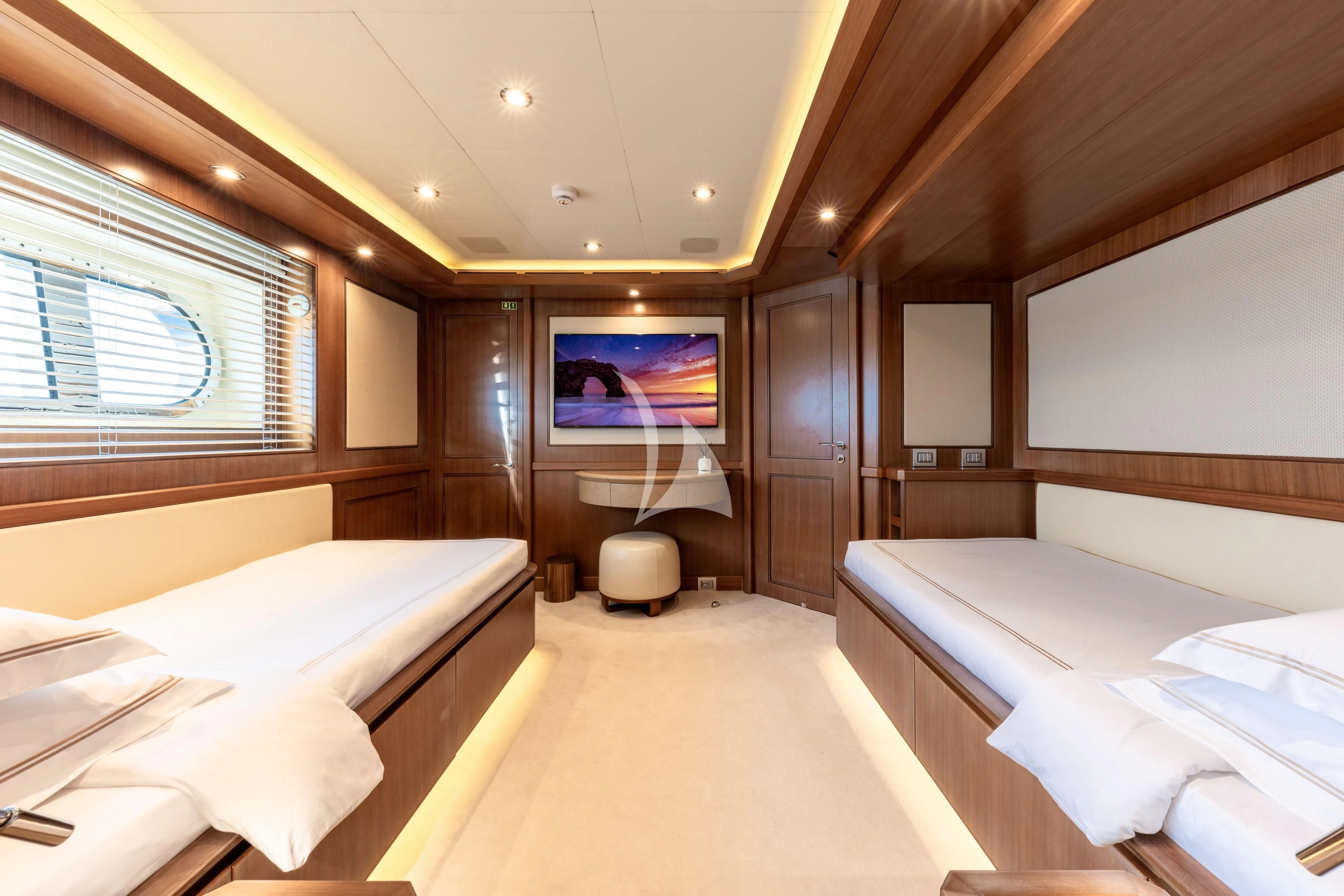 a room with beds and a tv aboard O'LION Yacht for Sale