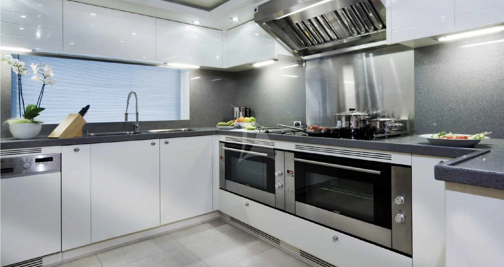 a kitchen with white cabinets aboard O'LION Yacht for Sale