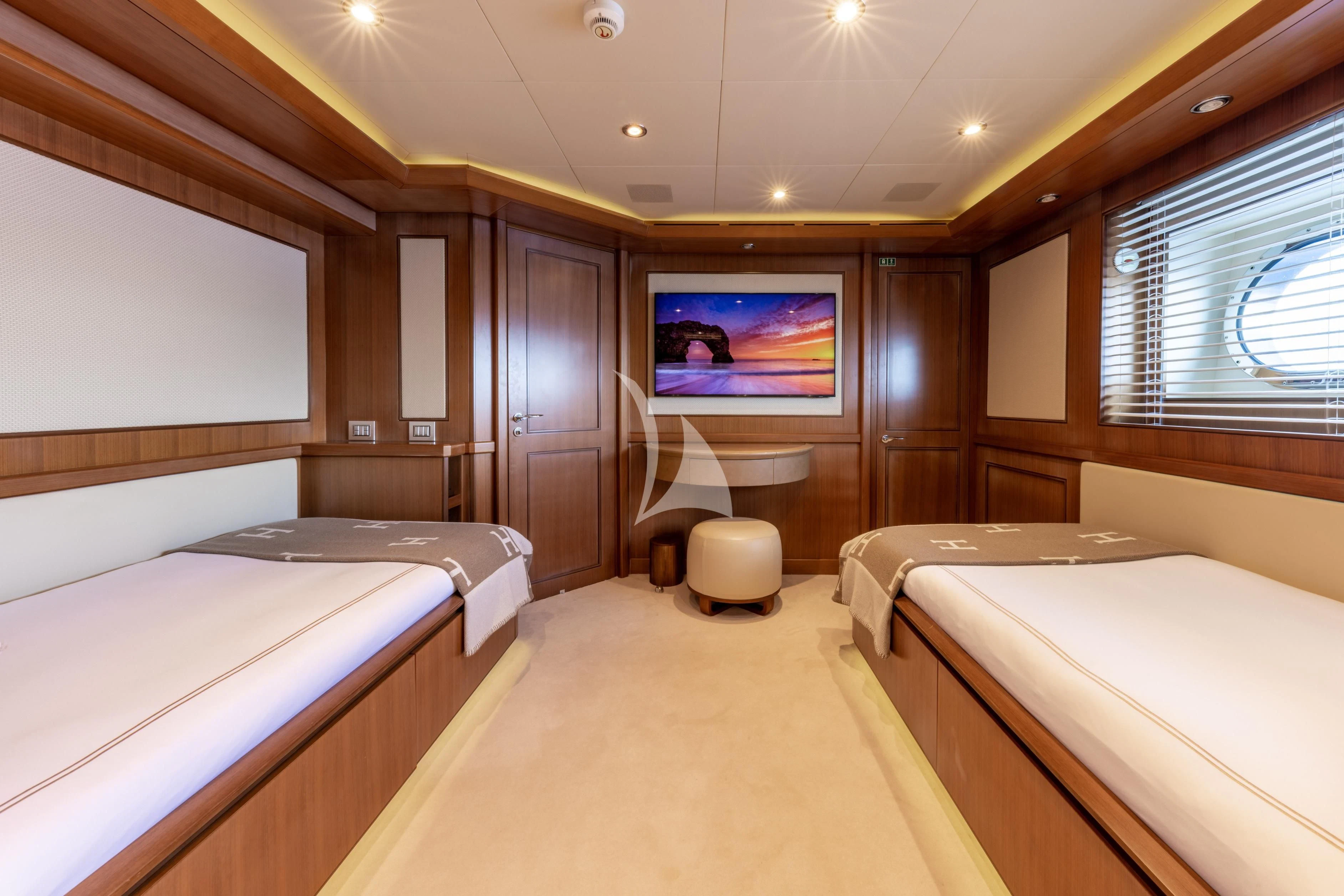 a room with two beds aboard O'LION Yacht for Sale