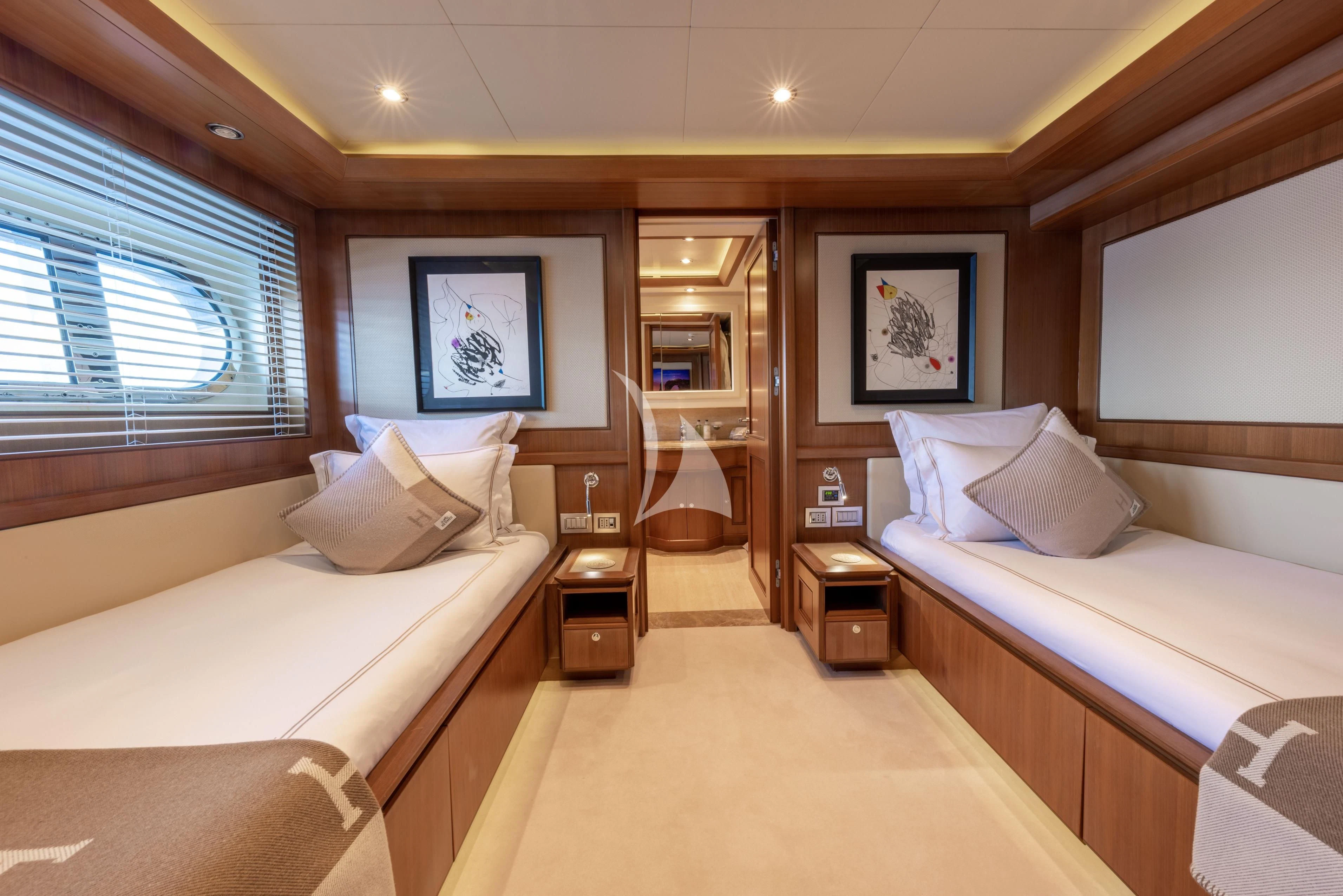 a room with two beds aboard O'LION Yacht for Sale