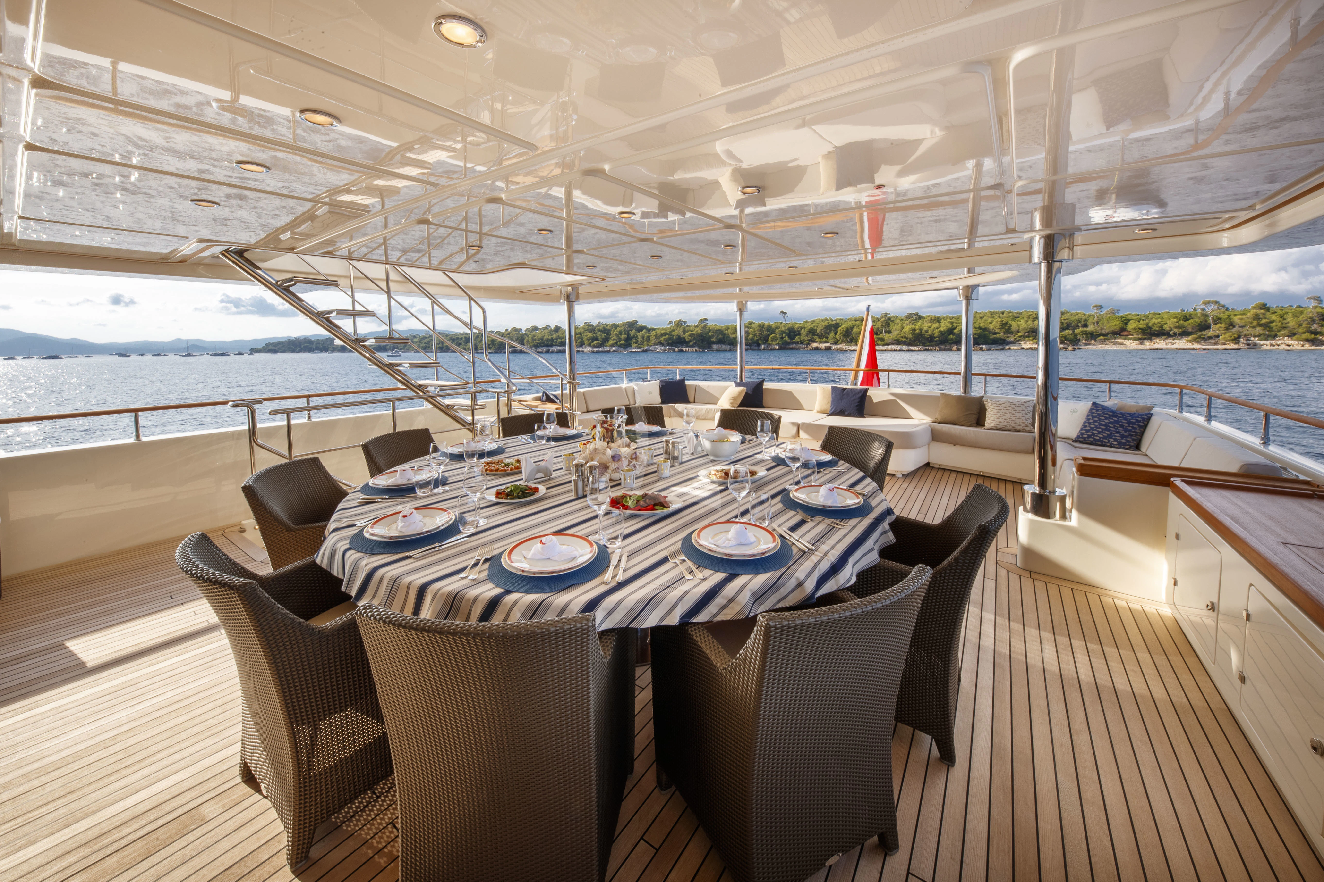 a table set for a meal on a deck aboard O'LION Yacht for Sale