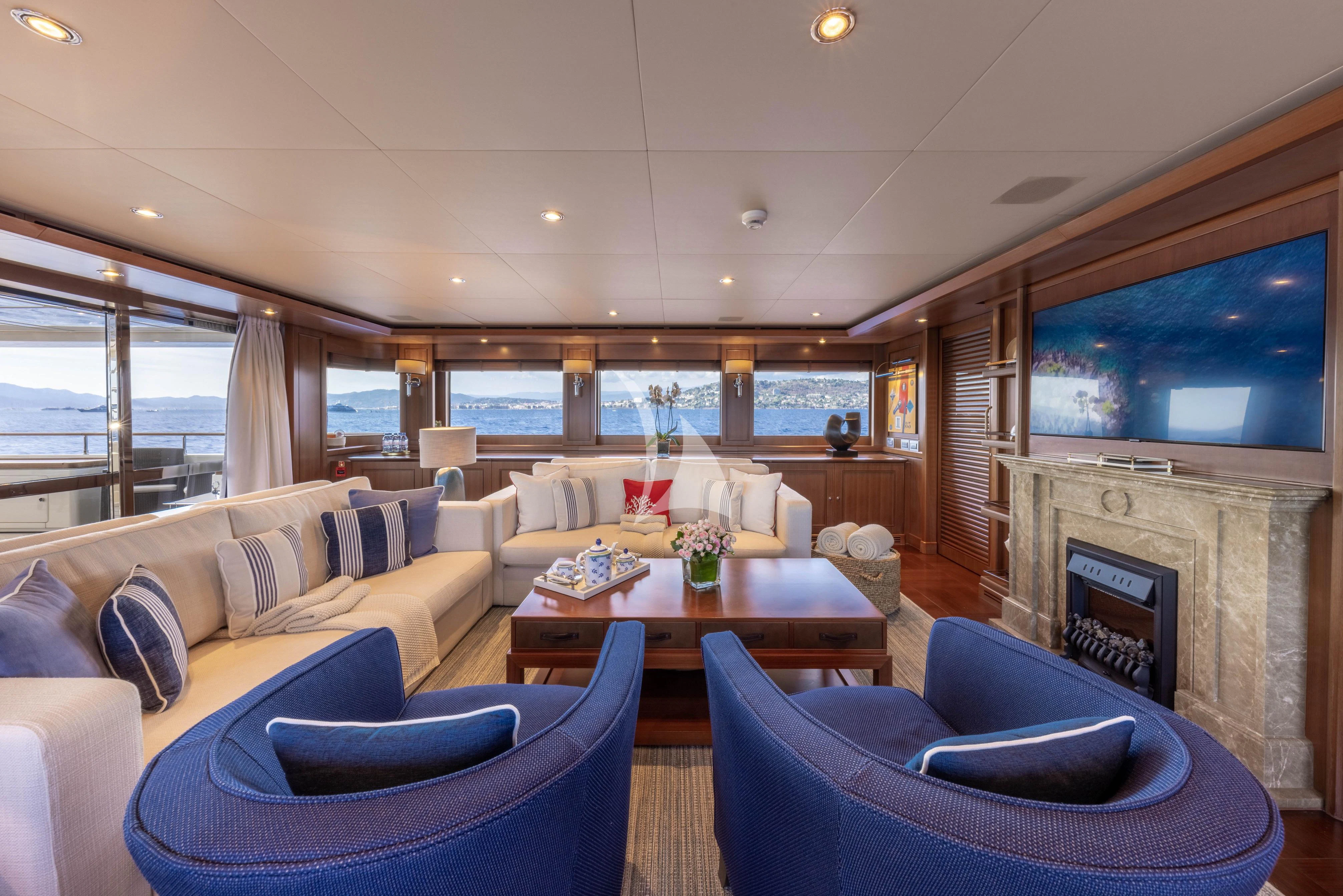 a living room with a fireplace aboard O'LION Yacht for Sale