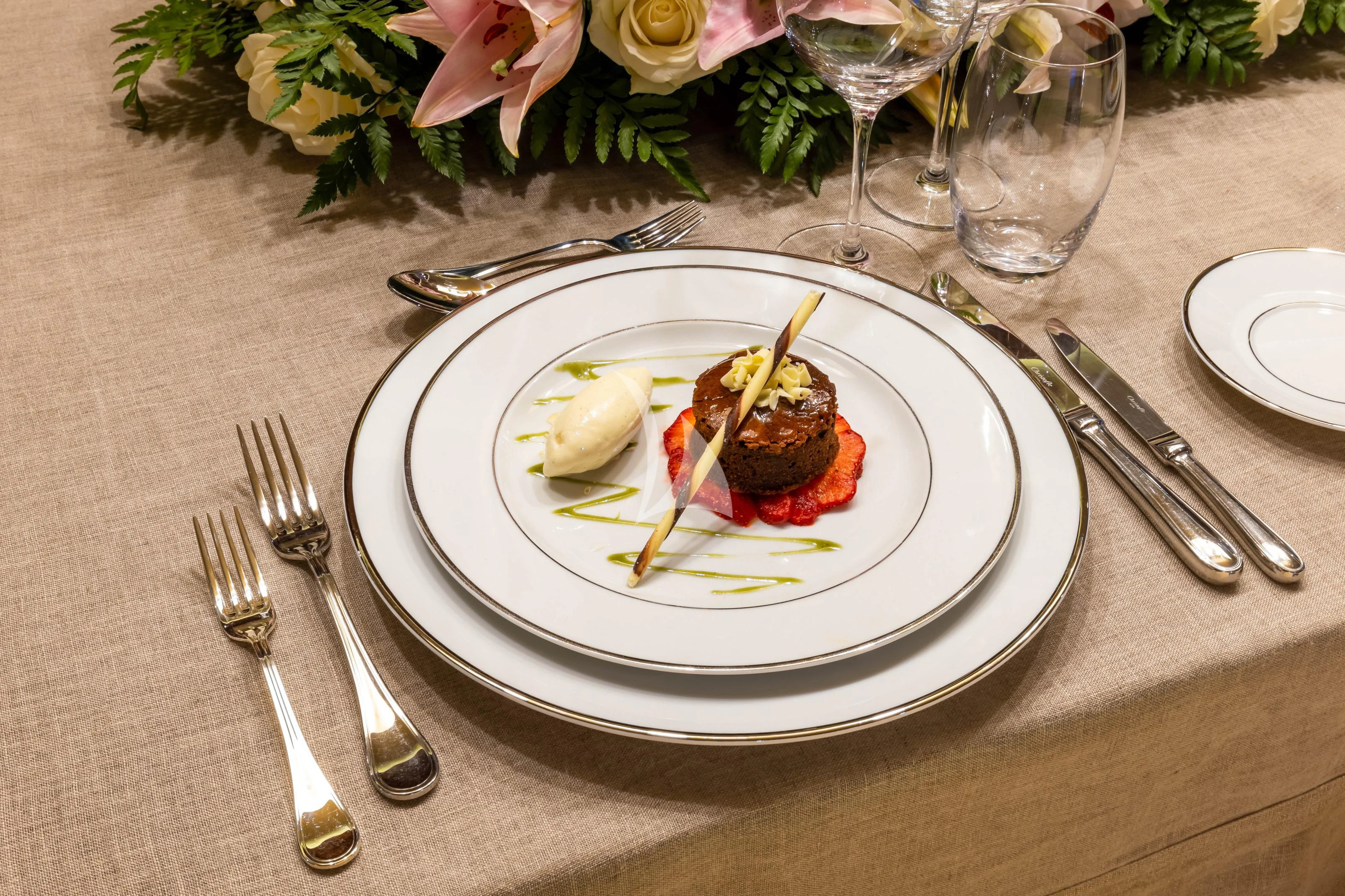 a plate of food and silverware on a table aboard O'LION Yacht for Sale