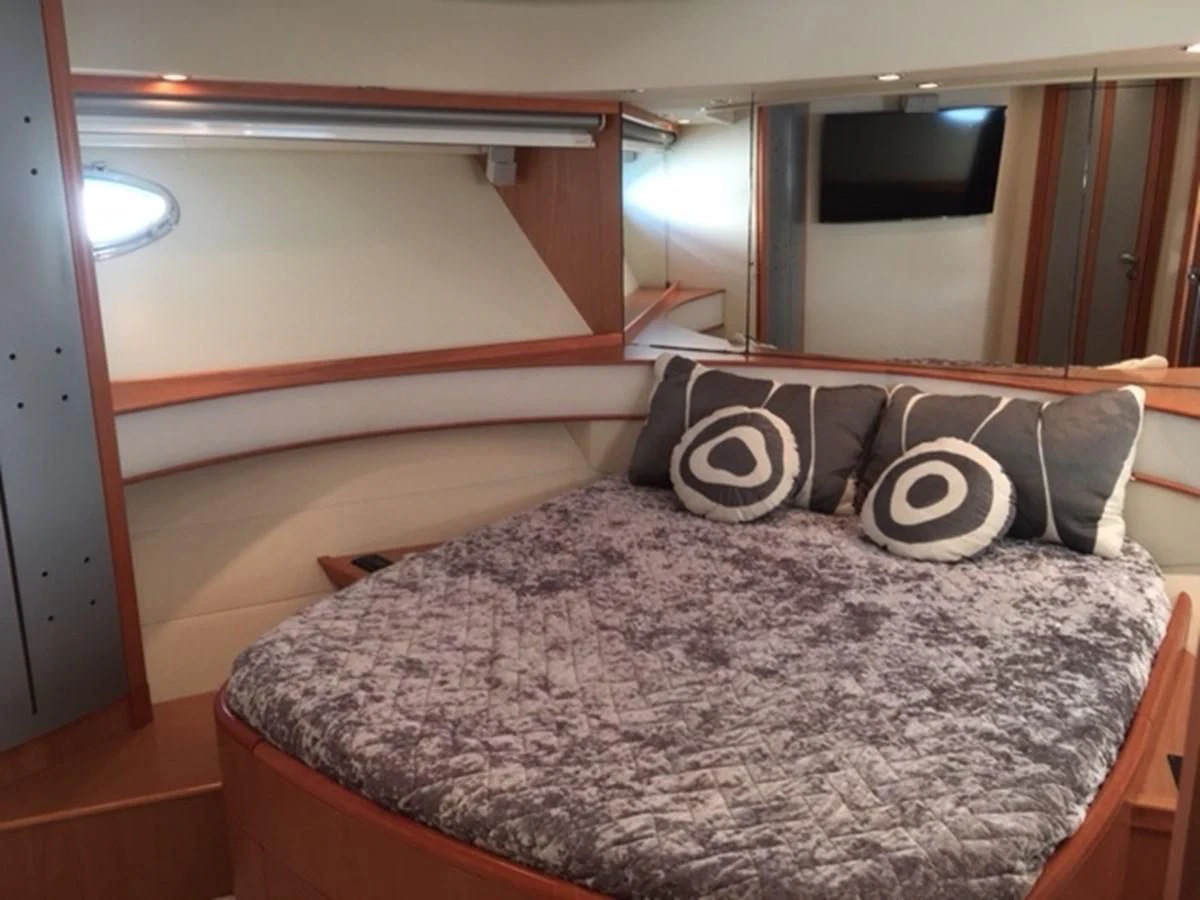 a bed with a blue comforter aboard CHAKLOO Yacht for Sale