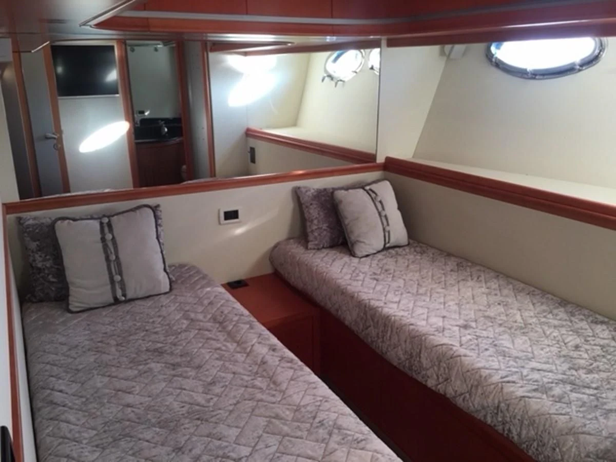 a couple of beds in a hotel room aboard CHAKLOO Yacht for Sale