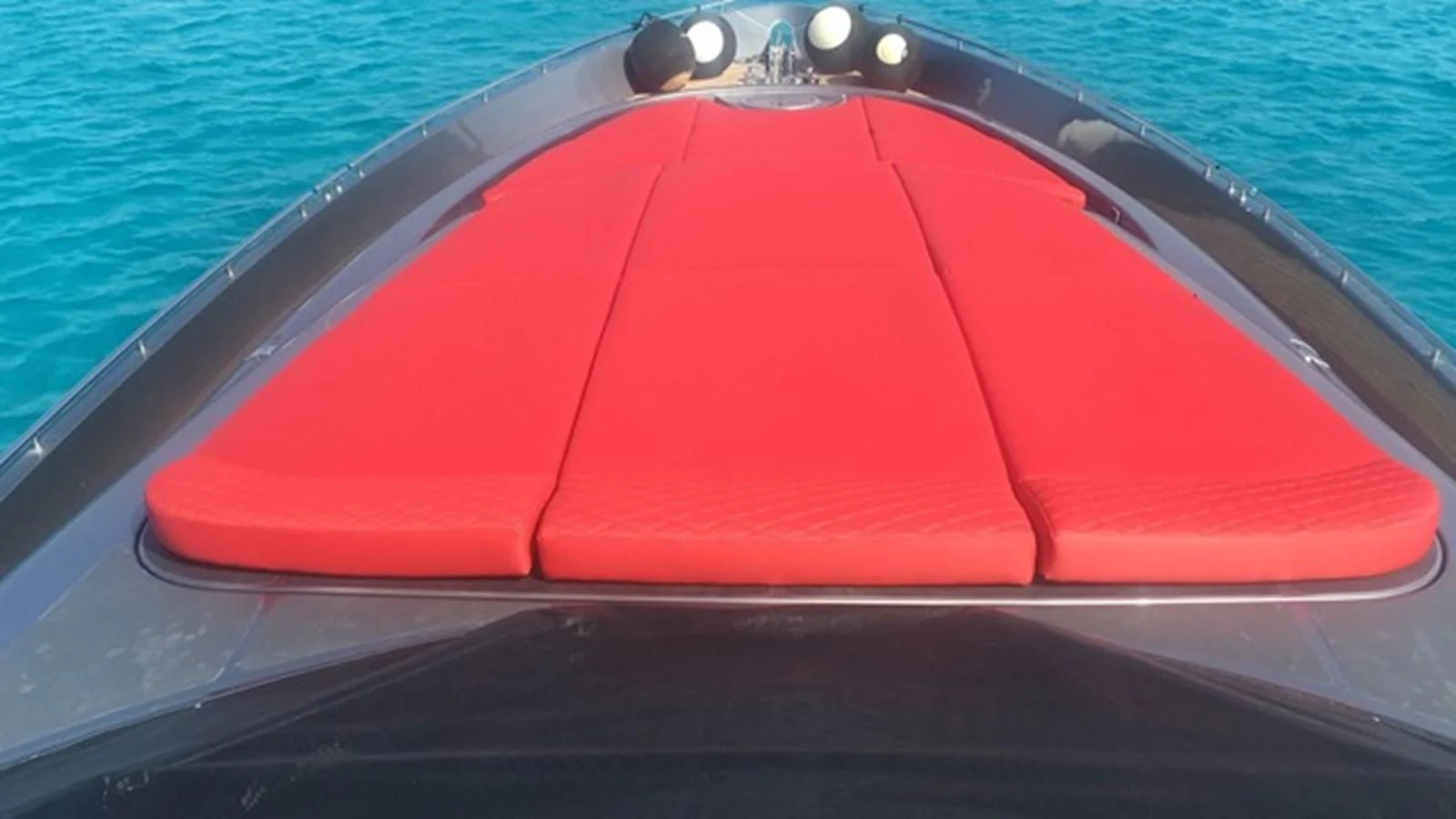 a red boat on the water aboard CHAKLOO Yacht for Sale