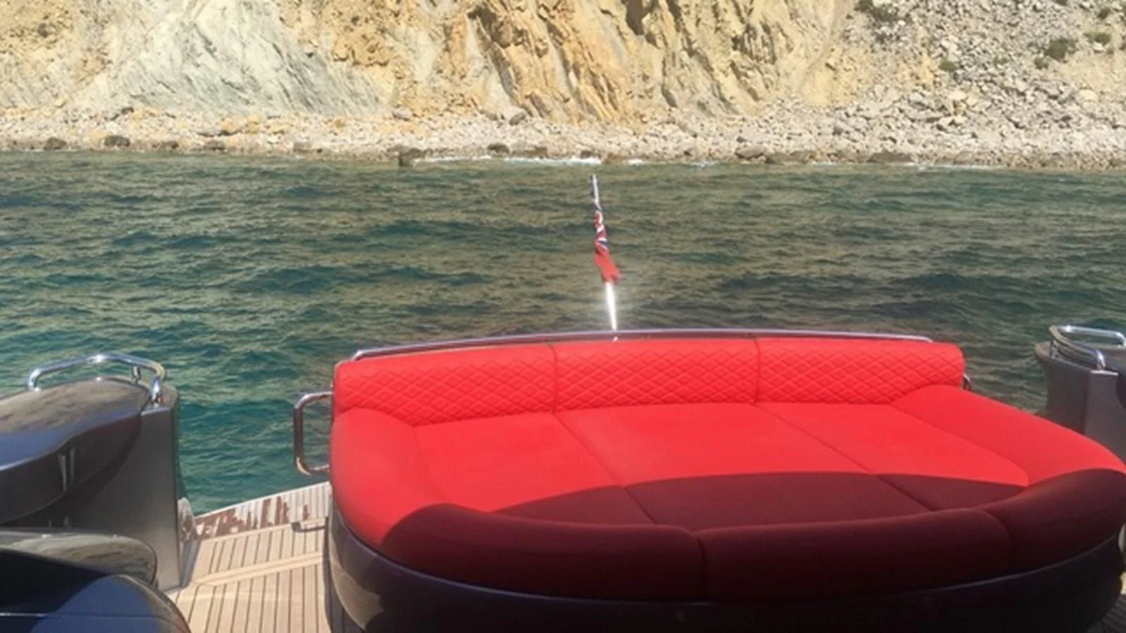 a red boat on the water aboard CHAKLOO Yacht for Sale