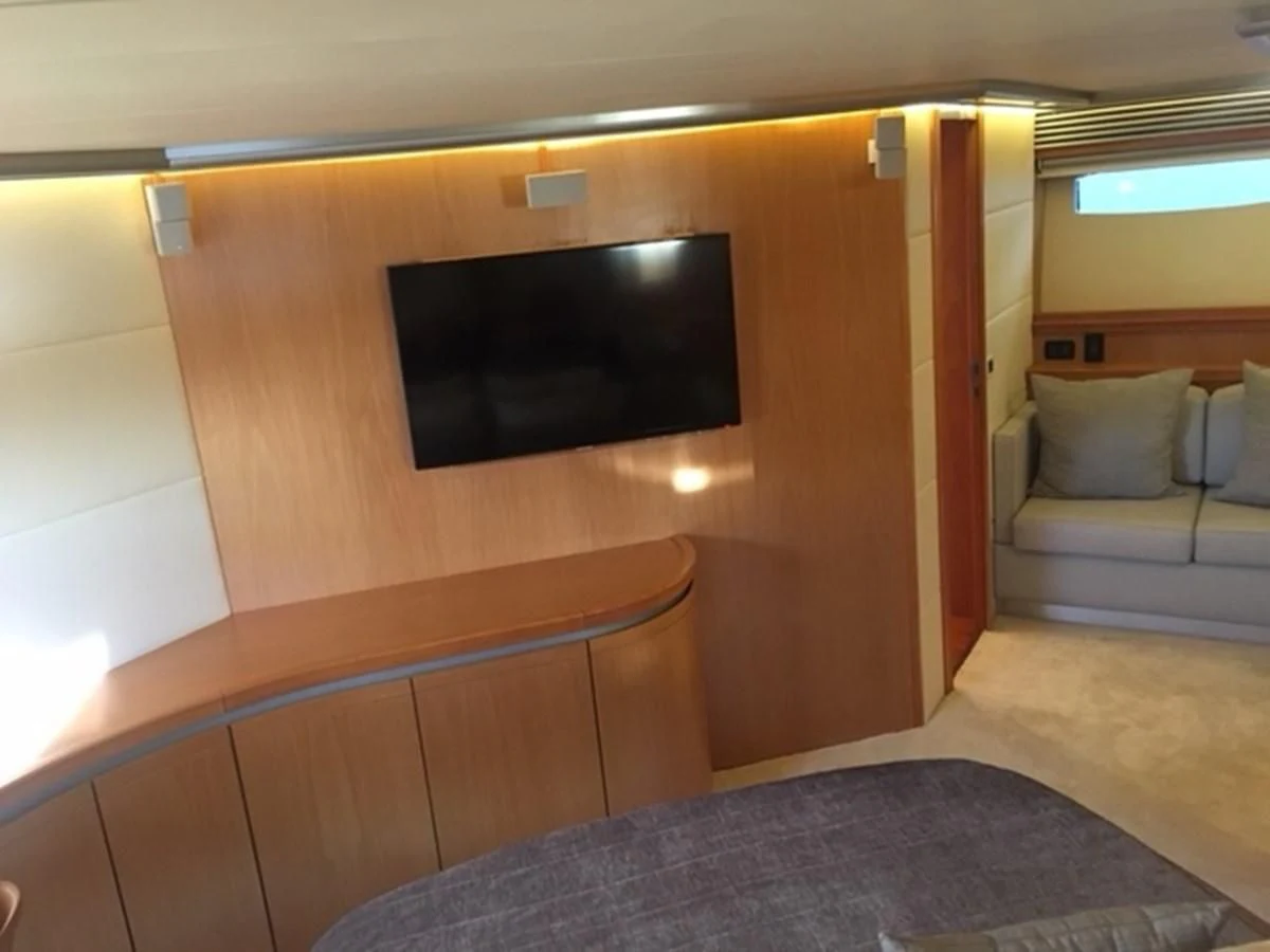 a room with a tv and couch aboard CHAKLOO Yacht for Sale