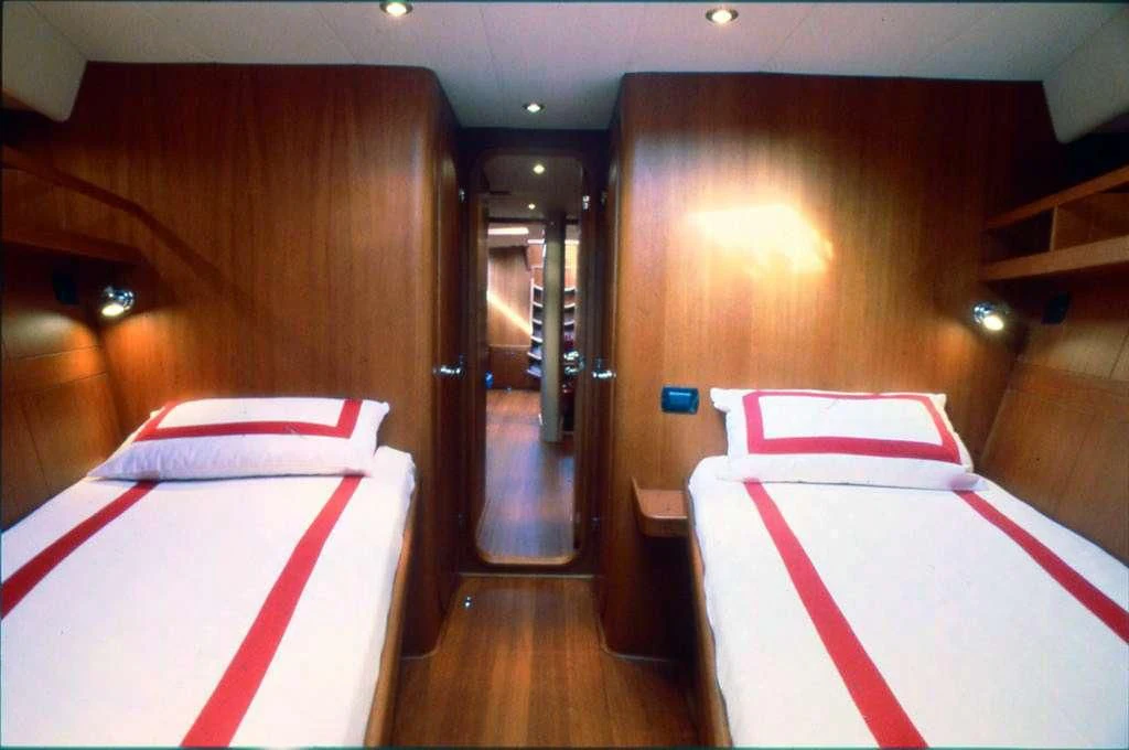 a room with a bed and a mirror aboard CLASS IV Yacht for Charter