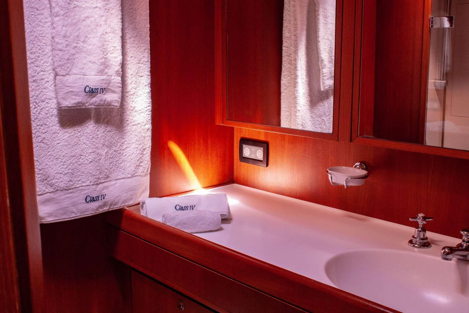 a bathroom sink with a towel aboard CLASS IV Yacht for Charter