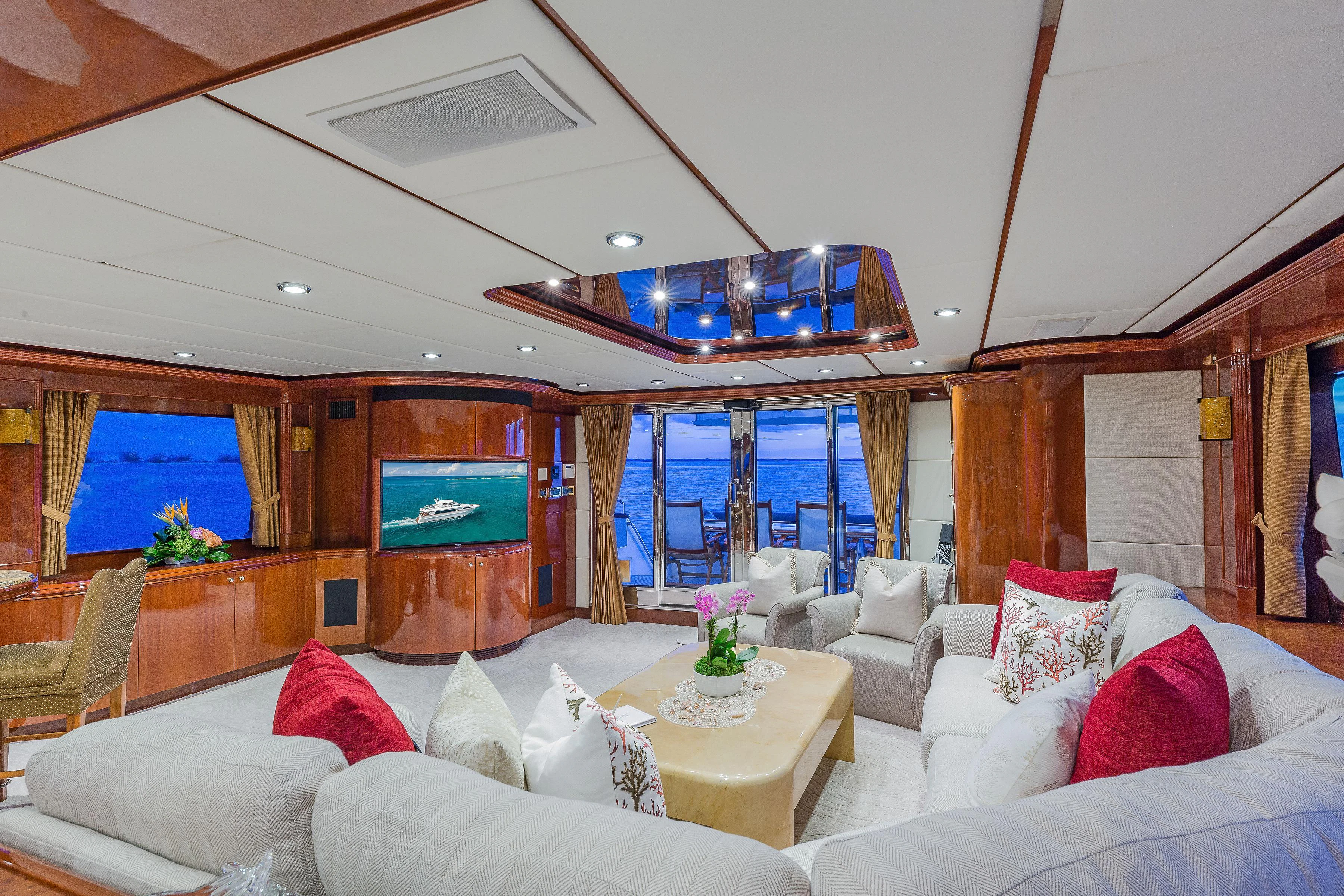a living room with a large screen aboard CAPRICE I Yacht for Sale
