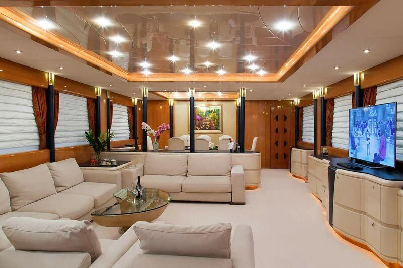 a living room with a large screen aboard CAPRICE I Yacht for Sale