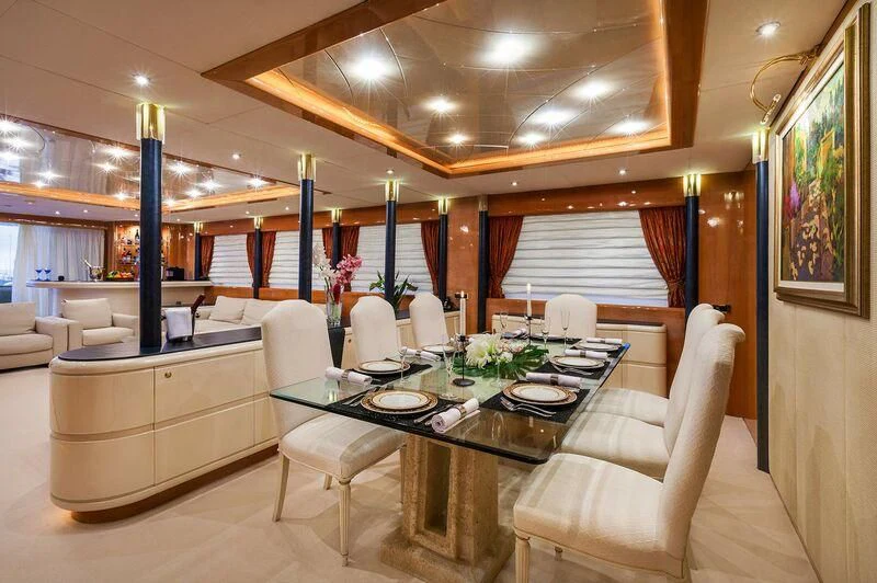 a dining room with a table and chairs aboard CAPRICE I Yacht for Sale